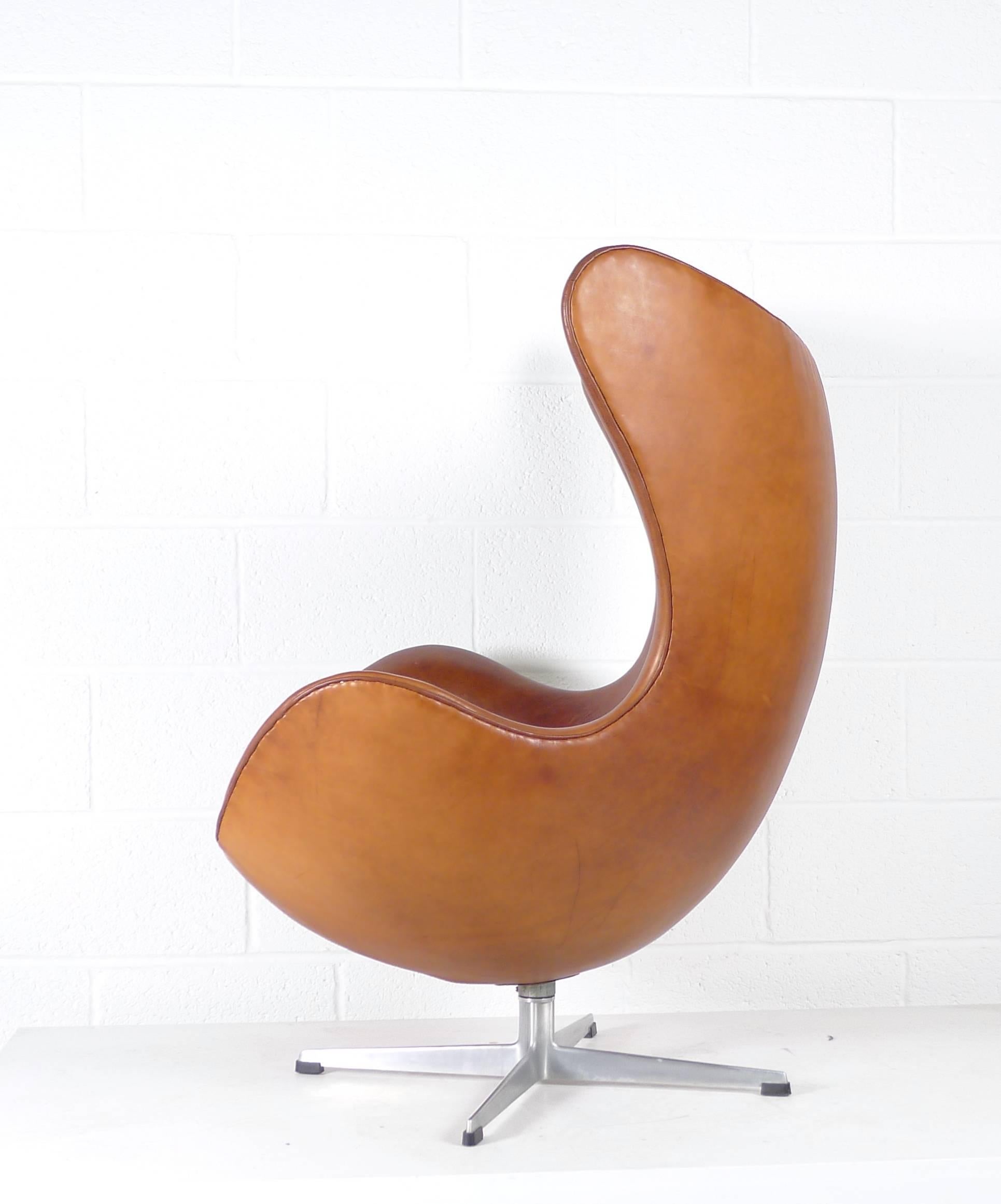 Absolutely stunning Arne Jacobsen Egg chair, designed for Fritz Hansen, Denmark, upholstered in a Classic Scottish leather as used for the interior of Morgan sports cars. A very early example with the deeper foot glides. 
Over time the leather will