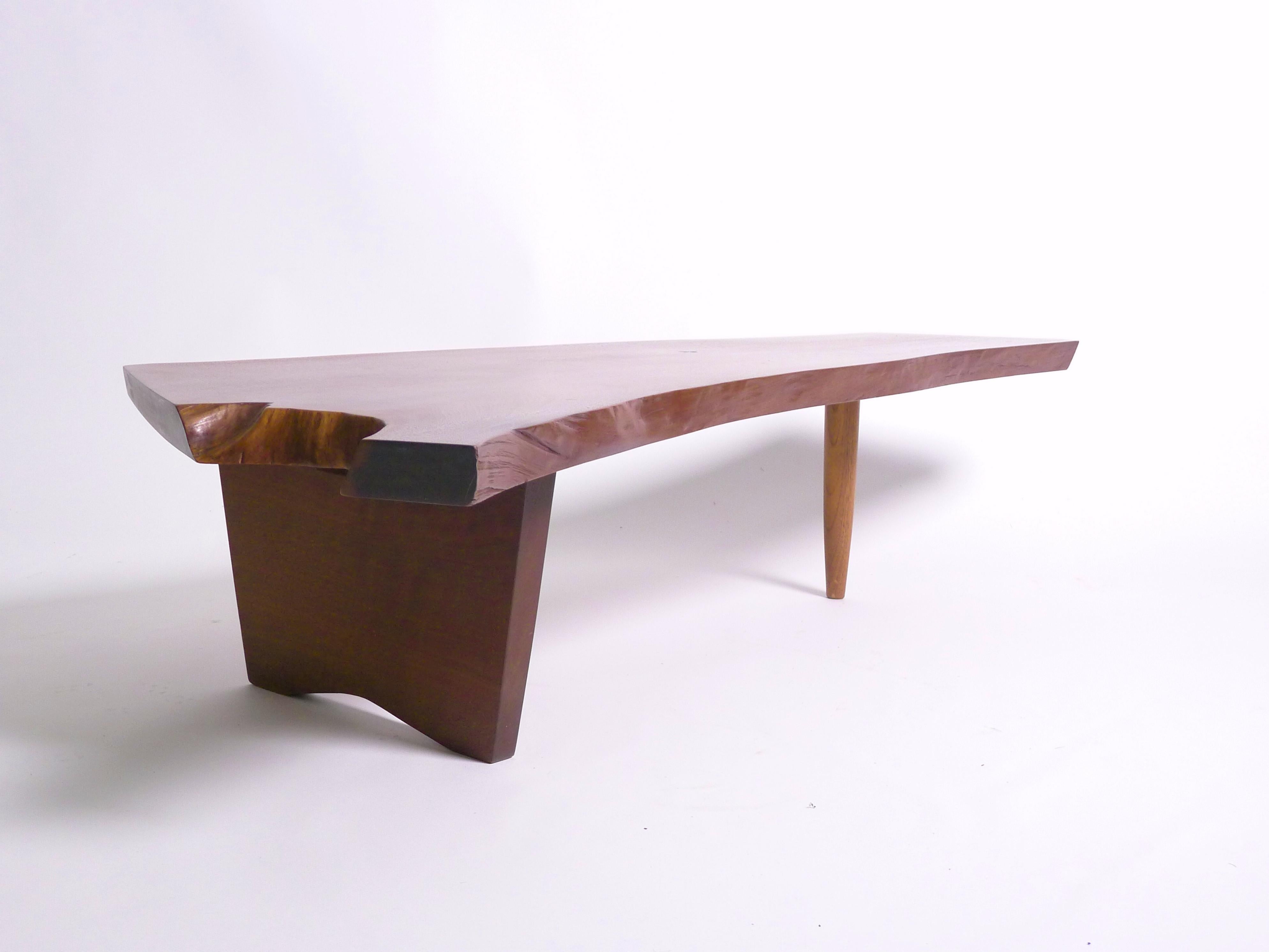 George Nakashima
Conoid Coffee Table, 1962
American black walnut single slab top with two free edges, several exposed knots, and expressive grain
Inscribed to underside with client's name
36cm high, 148cm wide, 76cm deep (maximum)

In excellent