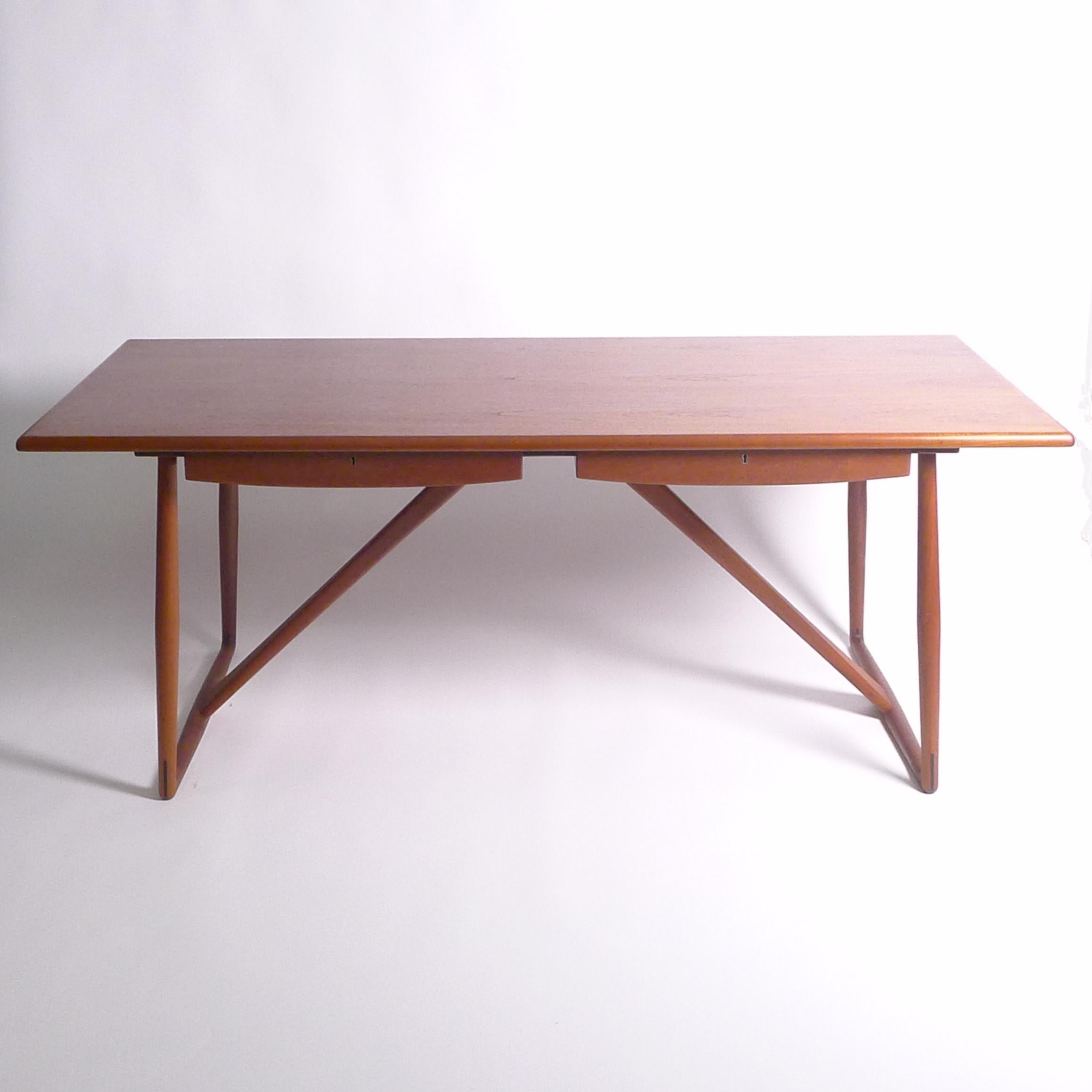 Aksel Bender Madsen and Ejner Larsen
Teak Partners' Desk, 1957
made by Willy Beck Cabinetmaker, Denmark
the planked top on turned spindle legs united by tapering supports to the centre, fitted two locking drawers to each side
73cm high, 186cm wide,