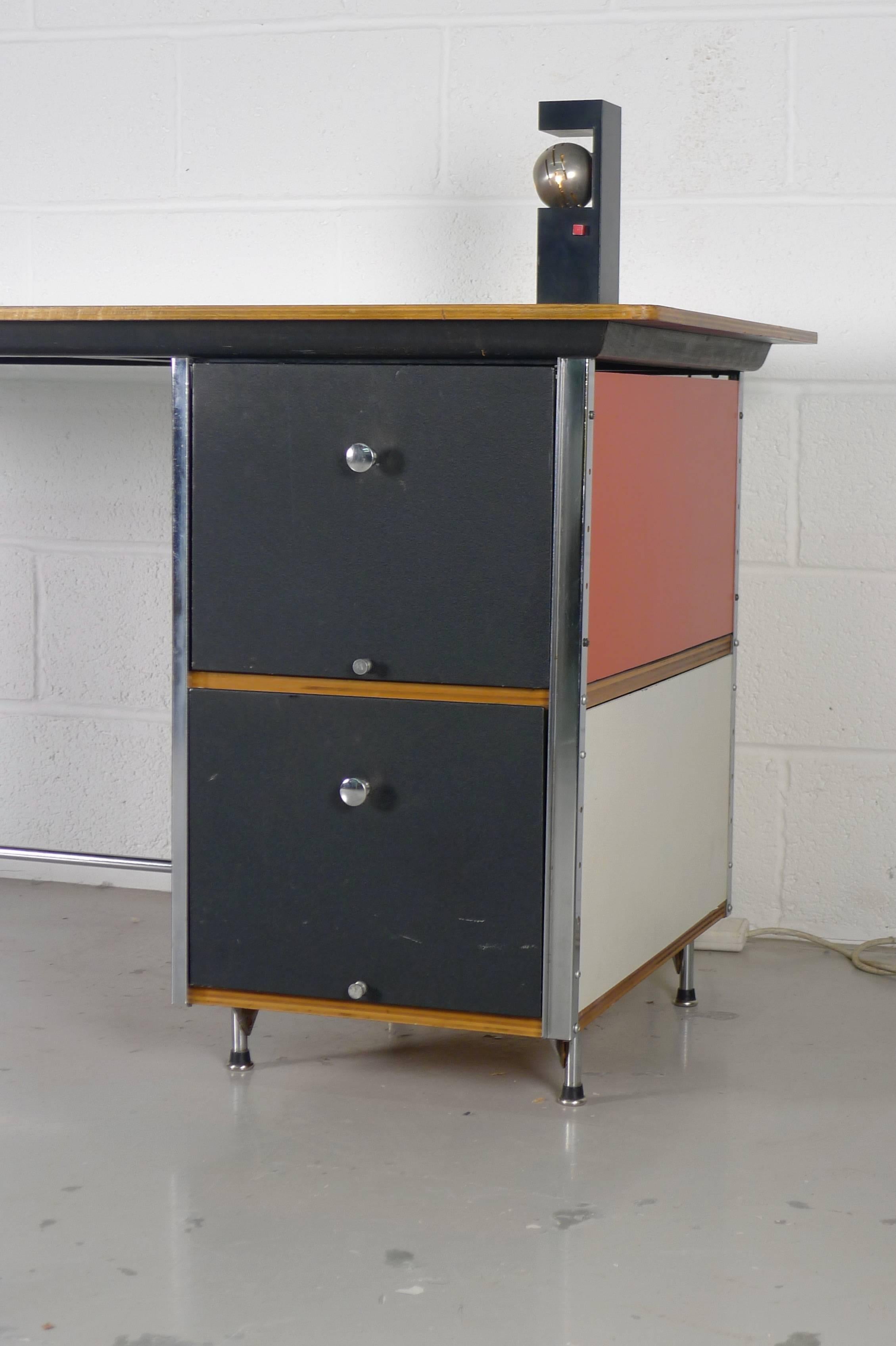 Charles and Ray Eames for Herman Miller, circa 1952, second series ESU desk with plywood top and colored panels. Drawers have original dividers.

Signs of age appropriate use to top.
