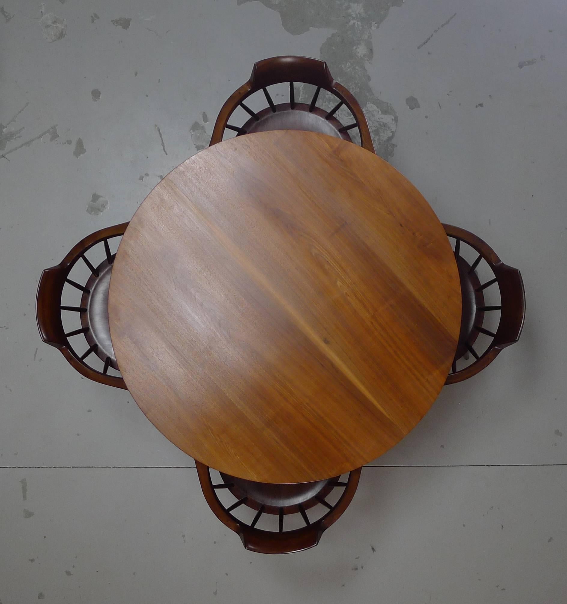 George Nakashima Studio, English walnut pedestal table and four captains chairs. 

Superb vintage condition. 

Dimensions given are for the table.