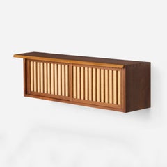 George Nakashima, Wall Hanging Cabinet, 1983, pandanus cloth doors, signed