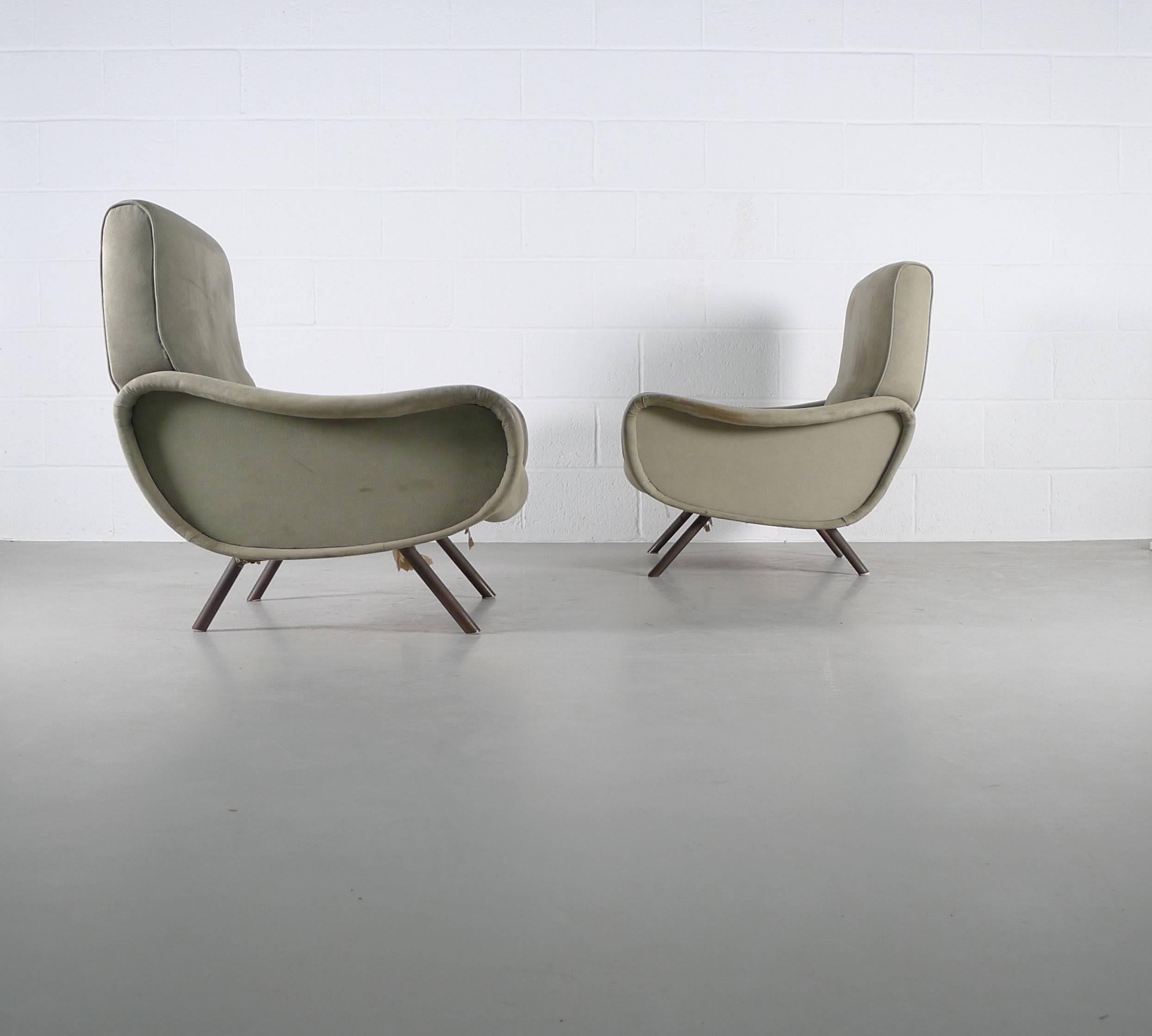 Marco Zanuso for Arflex, Italy, 1951. A pair of vintage Lady armchairs in their original coverings. These chairs will need re-upholstery to the new owners taste and decor as although the original covers are all in one piece there is a lot of
