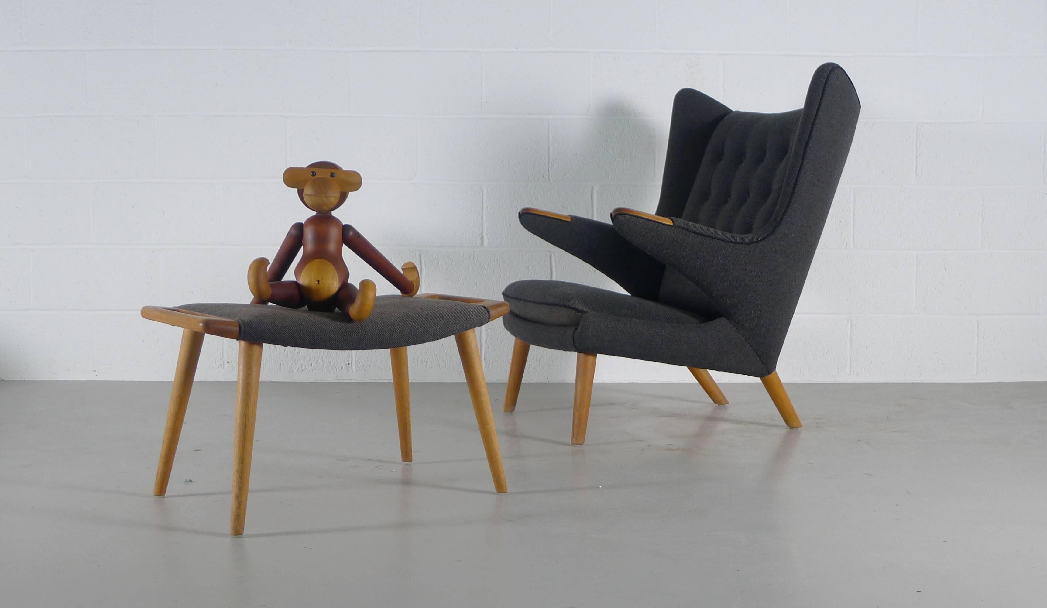 Hans Wegner for AP Stolen, Denmark, 1951. The iconic Papa Bear chair and en-suite ottoman nicely reupholstered relatively recently in a Kvadrat black/grey pin check with black piping. Paws and legs in nicely patinated Oak. 
Excellent overall