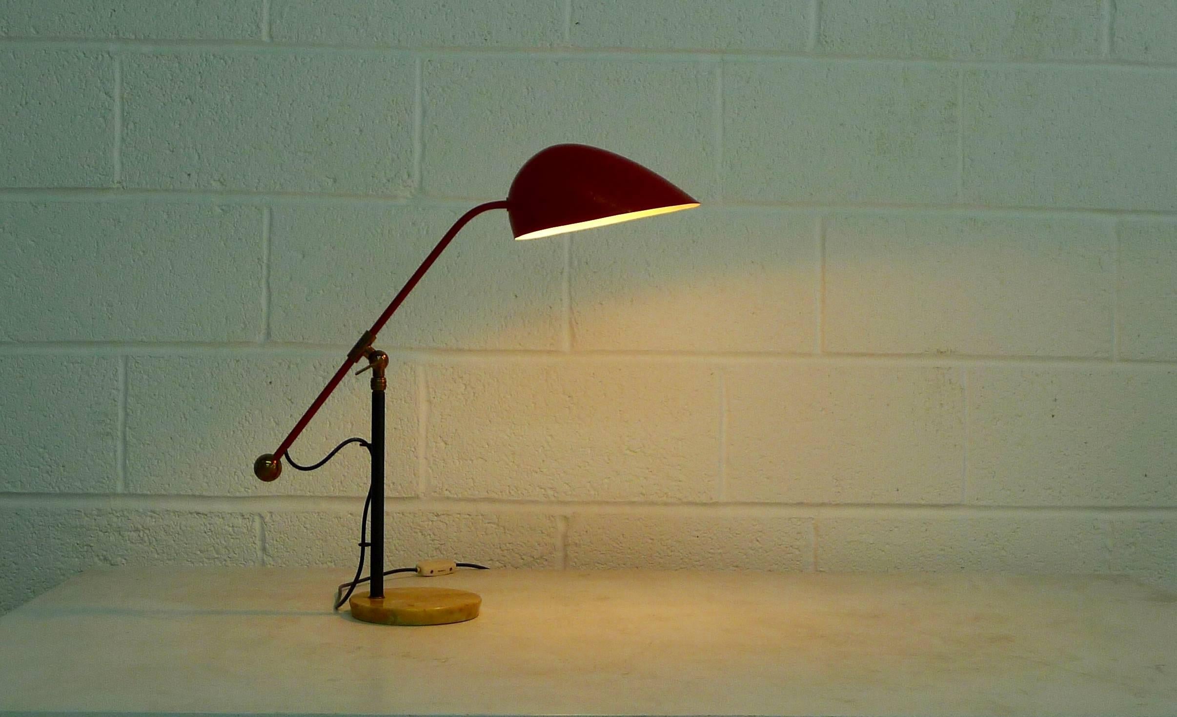 Angelo Brotto designed table lamp, Italy, 1960s.

Beautifully aged marble base, lower stem is black enamelled, brass upright is height adjustable from 57 cm to 80 cm through a locking ring at the top of the black section. The red enamelled arm