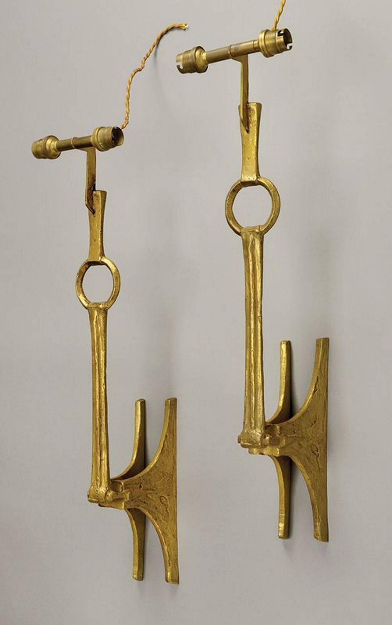 Pair of gilt bronze wallights, Model 'Etrier' designed by Felix Agostini. (1919-1980). Monogrammed F. Ag., France, circa 1960. Comes complete with bespoke shades.