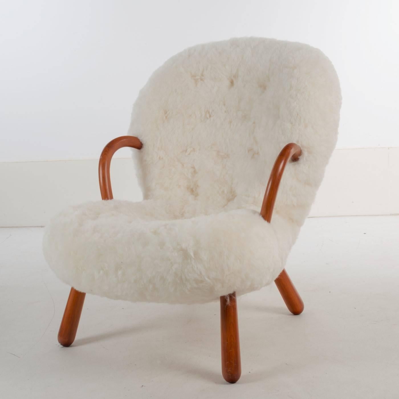 Pair of 'Clam' armchairs designed by the Danish architect Philip Arctander (1916-1994) with arms and legs of polished beech and reupholstered in shorn sheepskin. Designed in 1944 and produced in the late 1940s by Nordisk Staal & Møbel Central.