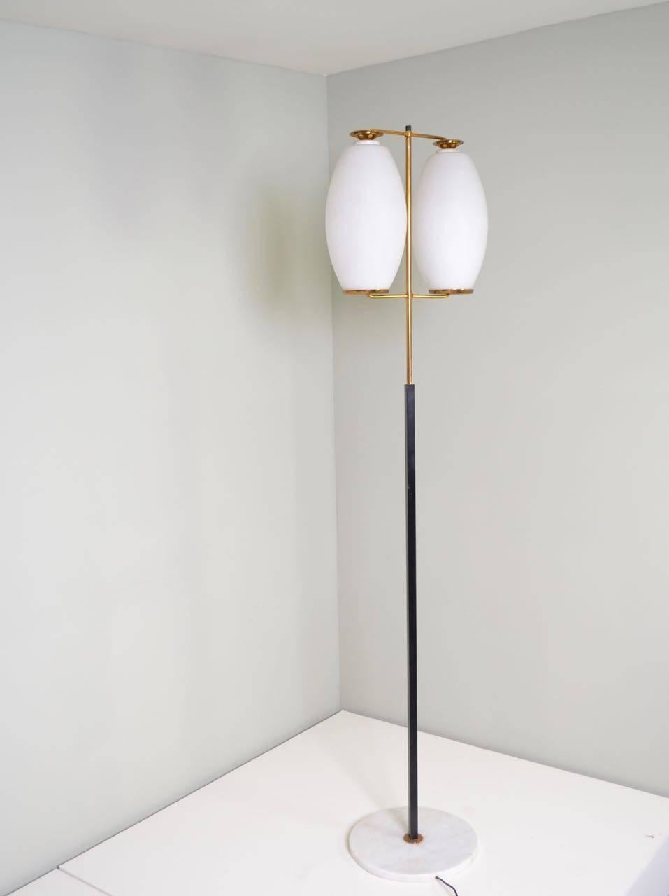 Stilnovo floor lamp with original label, published in the 
Catalogo Stilnovo No.11.
Black painted steel, lacquered brass, opaline glass shades and
a white marble base.