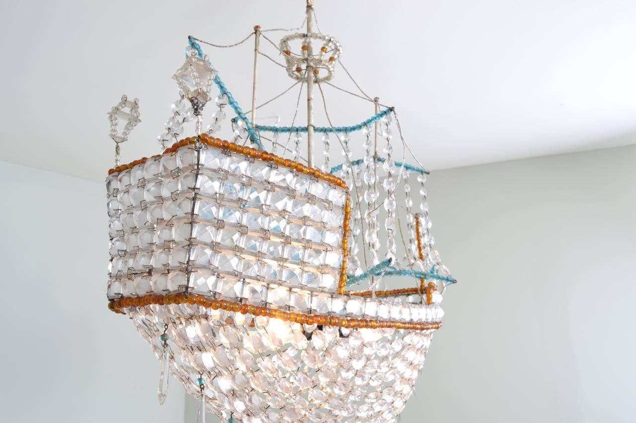Beaded glass boat chandelier manufactured in Spain, circa 1970.
This is a decorative and very effective light, but it is not of the
quality of the original Maison Bagues crystal boat lights first produced in the 1920s. This is a later copy