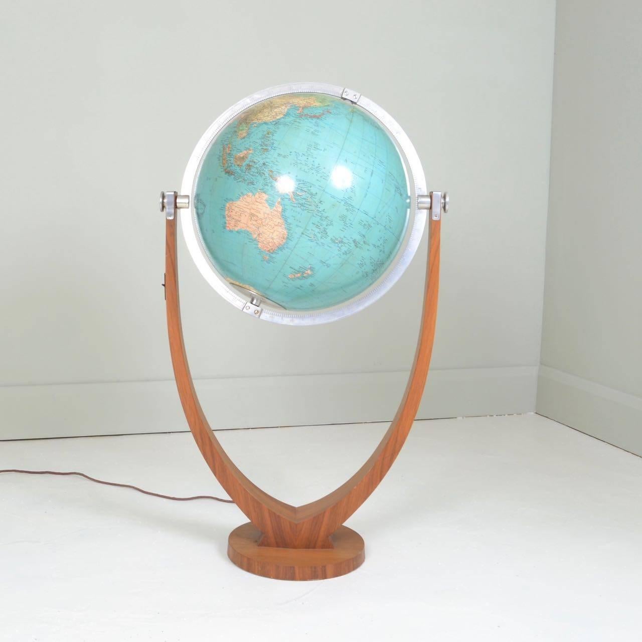 The Duo Globe designed by Paul Oestergaard.
Teak stand , engraved steel fittings, handblown 54cm illuminating 
globe and hand papered cartography.
Manufactured by Columbus Germany, circa 1950.