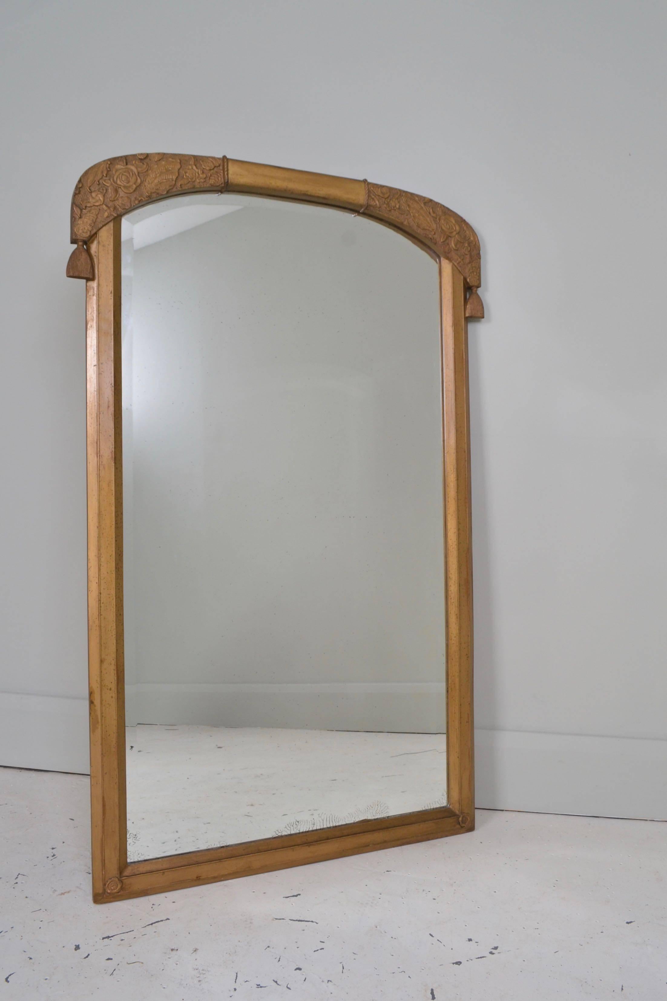 Gilded wood and plaster Art Nouveau mirror with carved stylized
Japanese flowers and swags. The original mirror plate has some
oxidization marks and a smart hand bevelled detail to the outside of the glass.