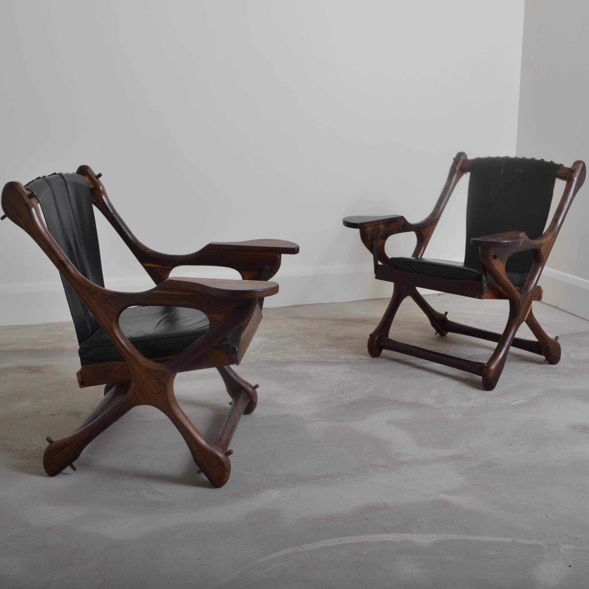 Pair of lounge chairs with rocking seats designed by Don Shoemaker. Retaining the original "Senal, Mexico" label.
Cocobolo wood with black leather.