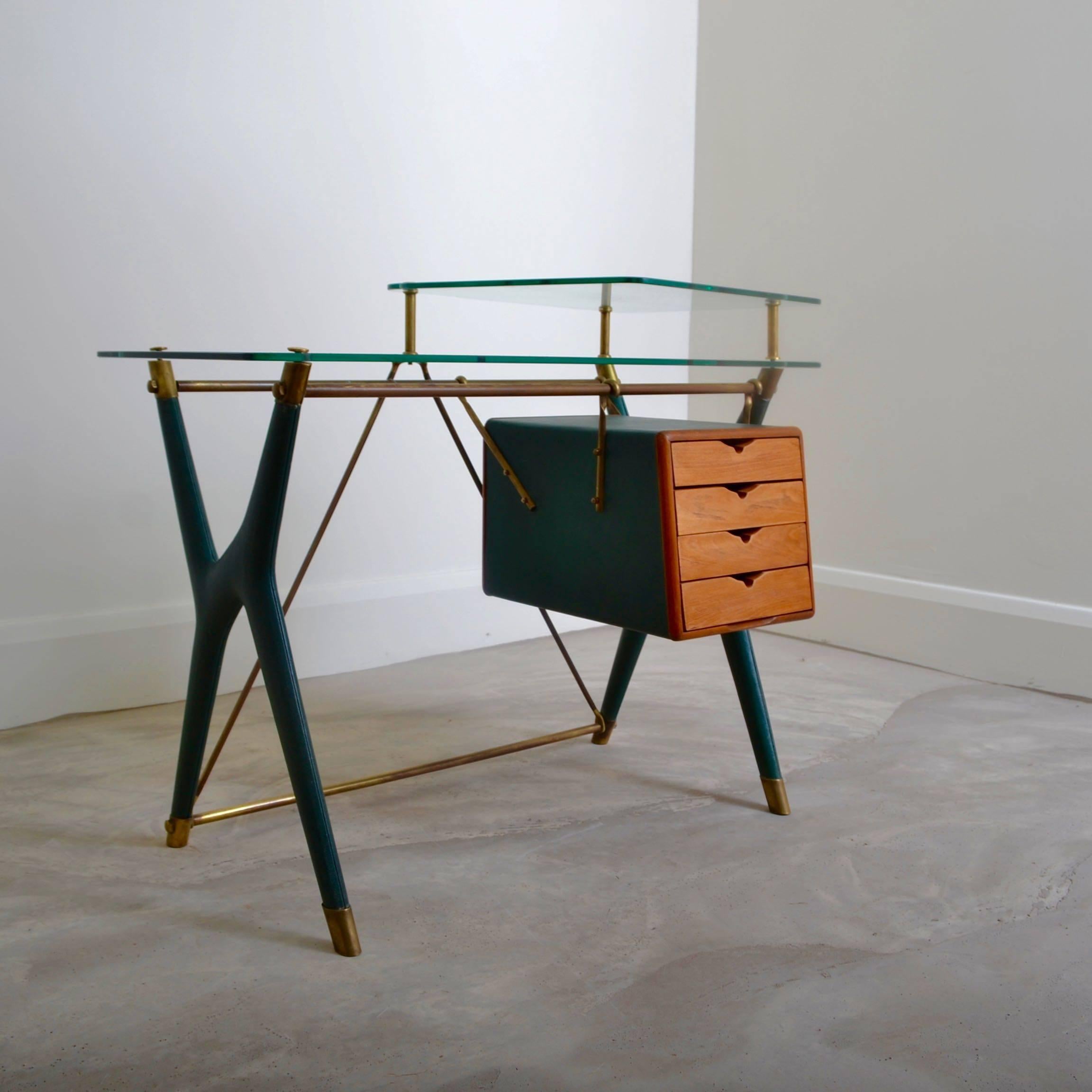 Desk designed by Silvio Berrone and manufactured by V.I.S 
(Vetro Italiano di Sicurezza). Green faux leather, lacquered brass, walnut
and security glass stamped VITREX. The architect Silvio Berrone designed the company headquarters and its
