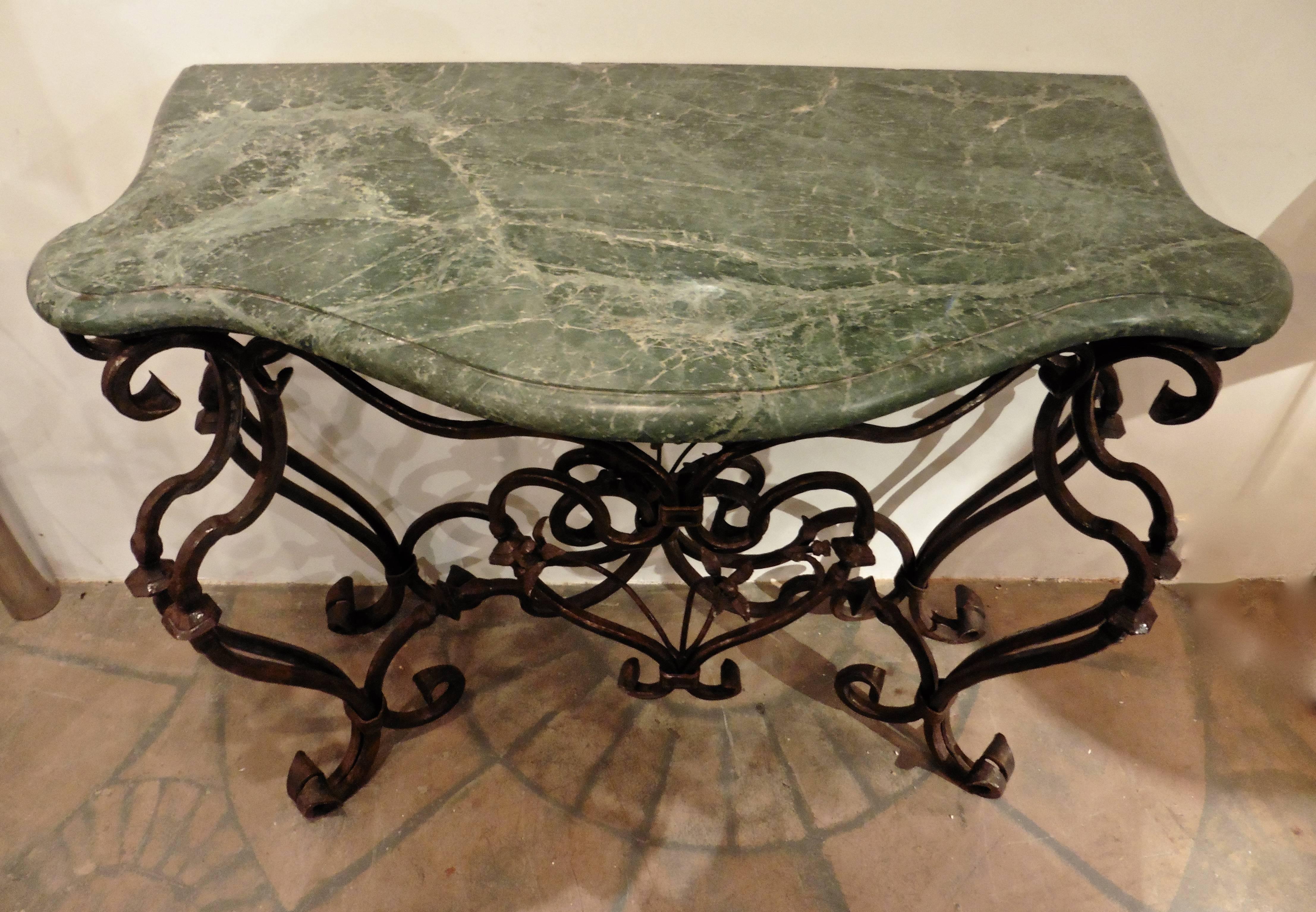A wonderful pair of Italian wrought iron console tables, circa 1900. Each shaped green marble top supported by an elaborately designed scrolled wrought iron frame with floral motifs.
 

  