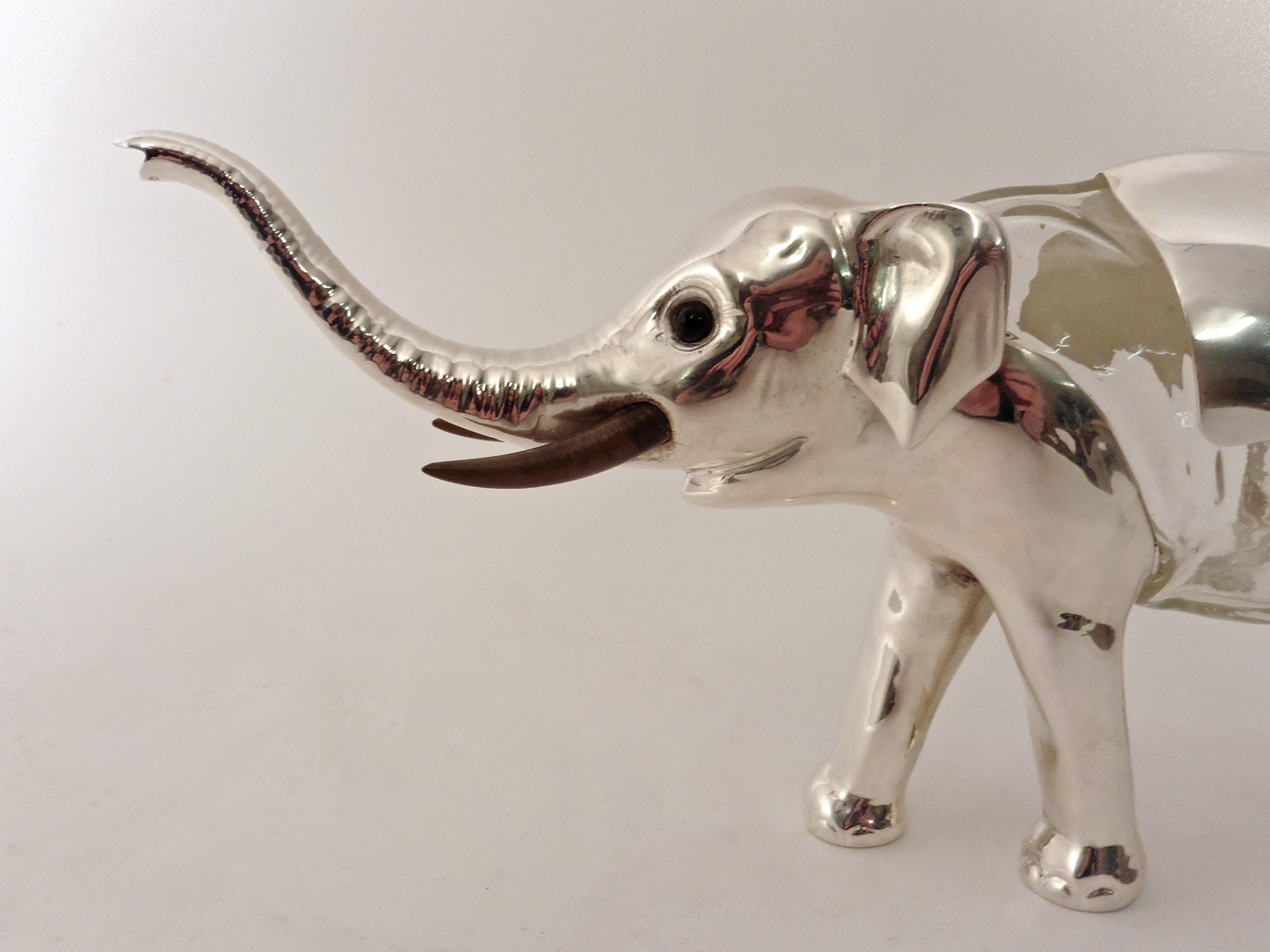 A charming Austrian silver plate and glass novelty elephant claret jug, circa 1920. With colored glass eyes and painted faux ivory tusks.

 