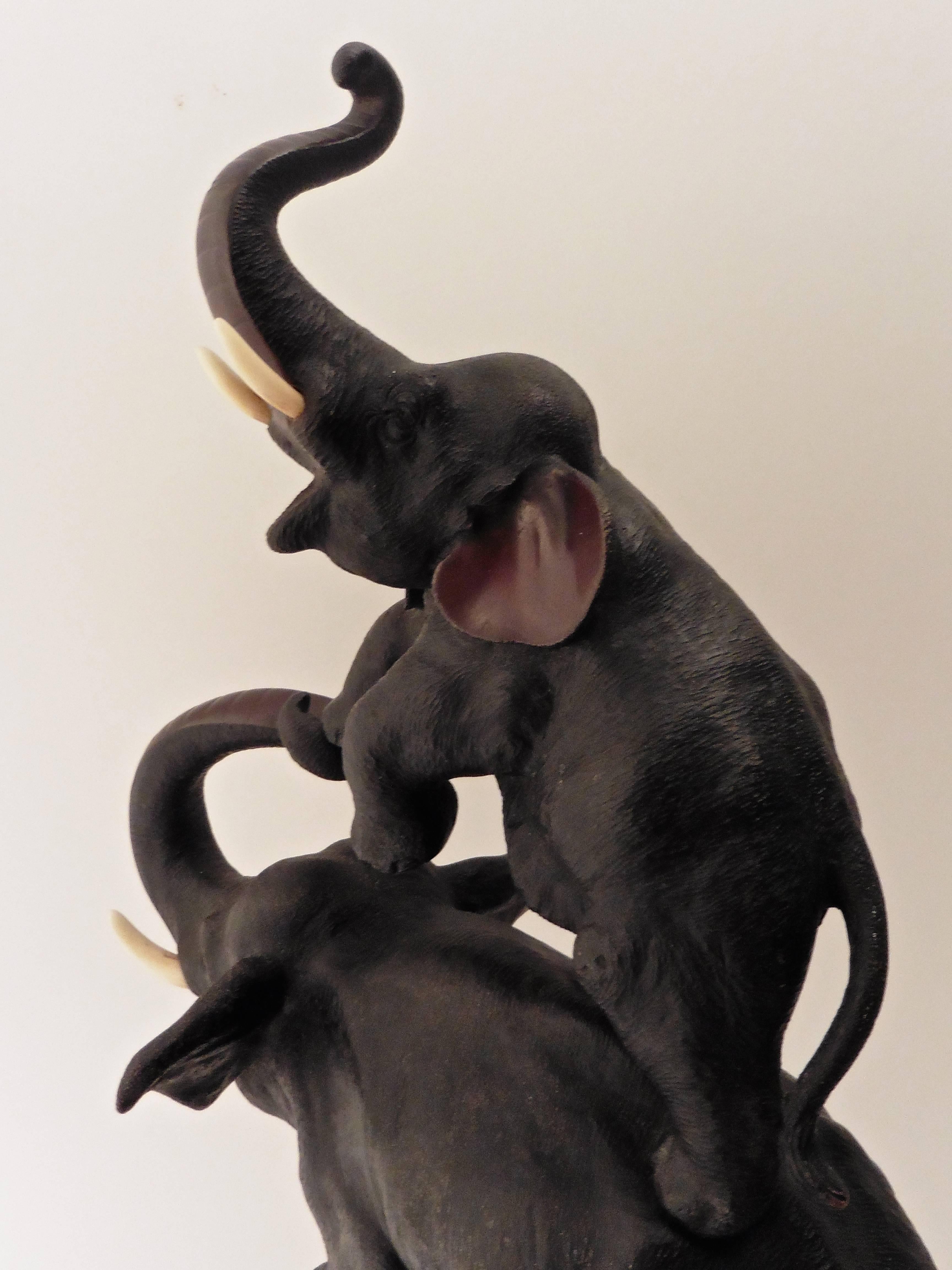 A delightful Japanese bronze of an elephant and calf balancing on a circus ball supported by a root wood Stand, circa 1900. 

 
 

  