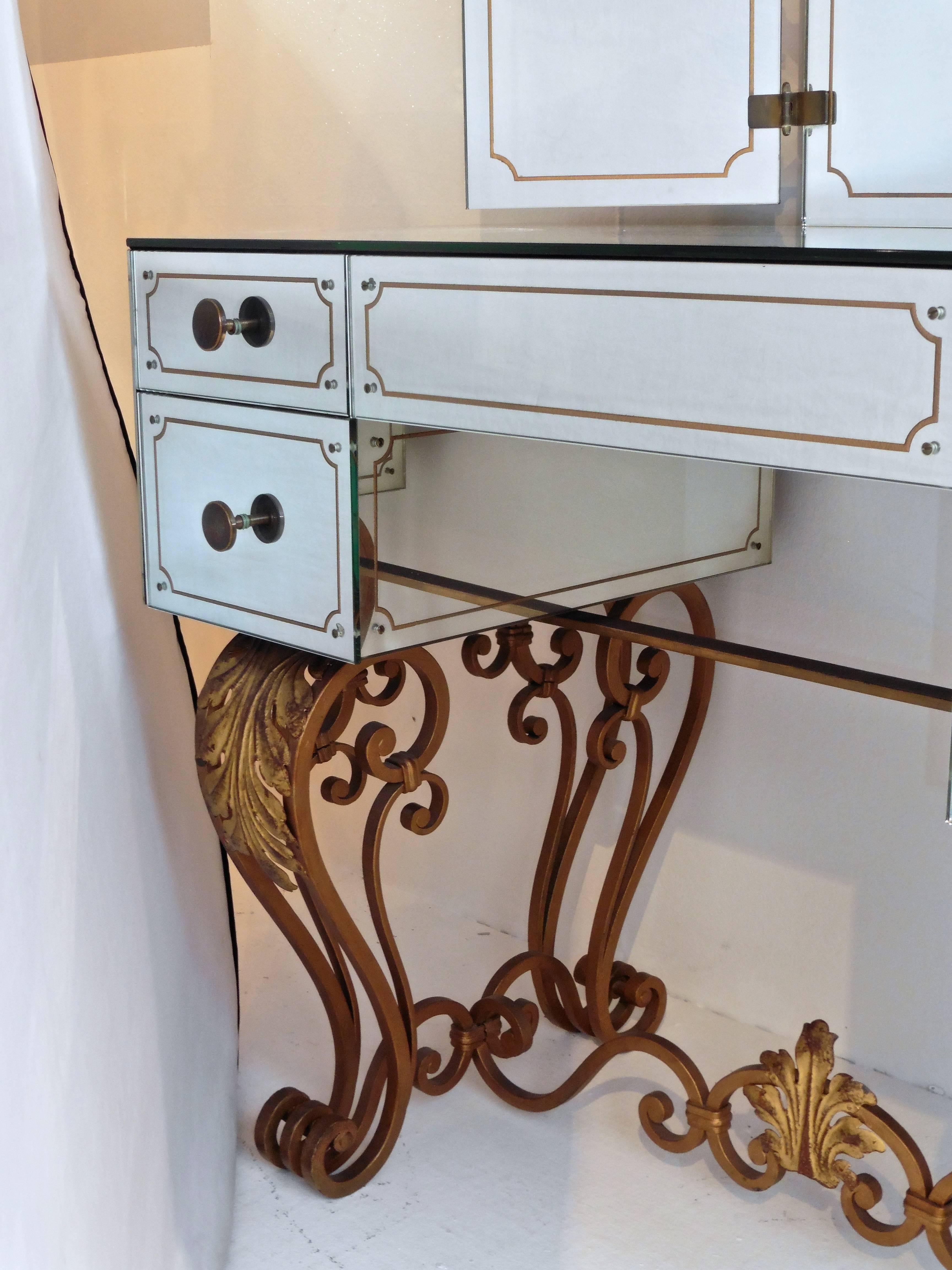 An extremely decorative French mirrored dressing table, circa 1950. The cabriole legs embellished with gilt acanthus leaves, connected by a stretcher of the same theme. The sides flanked by two drawers, one larger than the other. A three-fold