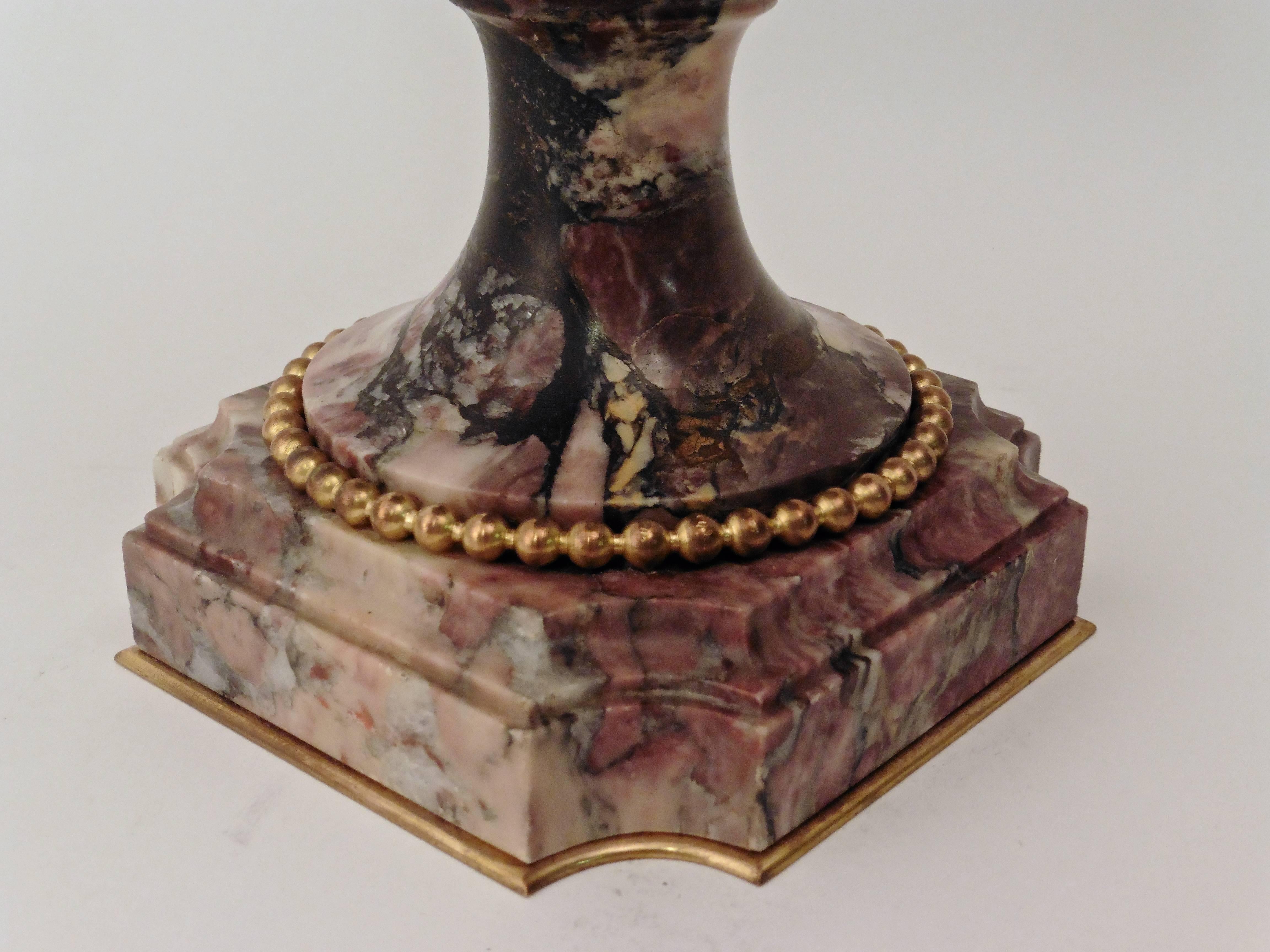 Pair of French ormolu-mounted ‘Breche Violette’ marble urns and covers, stamped ‘Susse Freres’ (Parisian foundry), circa 1880. Each Urn on stepped marble plinths with ormolu beading. Flanked by over scale acanthus leaf mounts. Marble lid finished