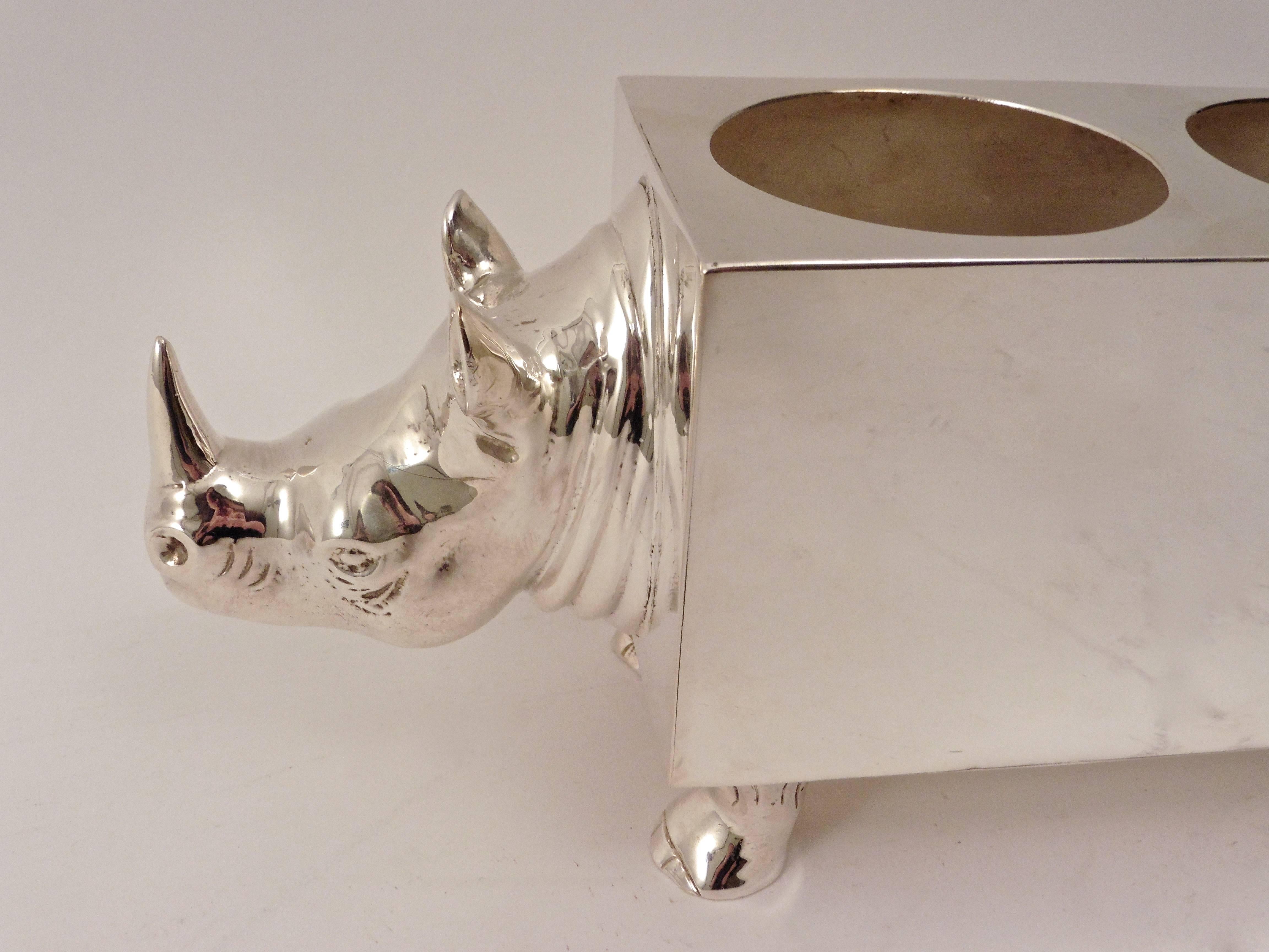 An unusual 20th century silver plate Spanish double wine holder in the shape of a Rhinoceros. The rectangular body a stark contrast to the realistic form of the head, tail and feet.