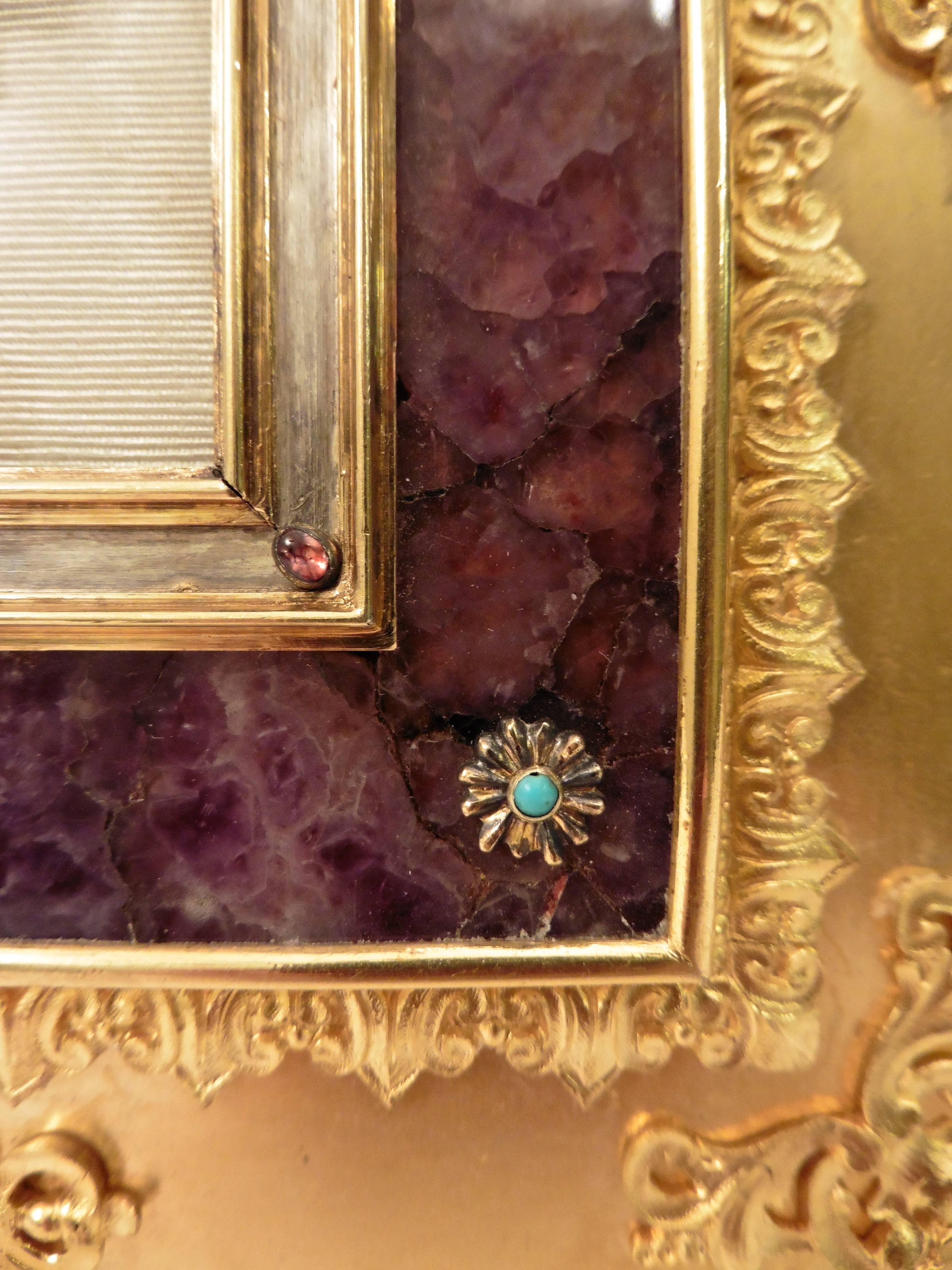 A striking French ormolu photo frame, circa 1890. With a classical border applied to the inside and outside section on the ormolu frame, and further applied swirling acanthus leaves. The raised central section of Blue John, with eight applied floral