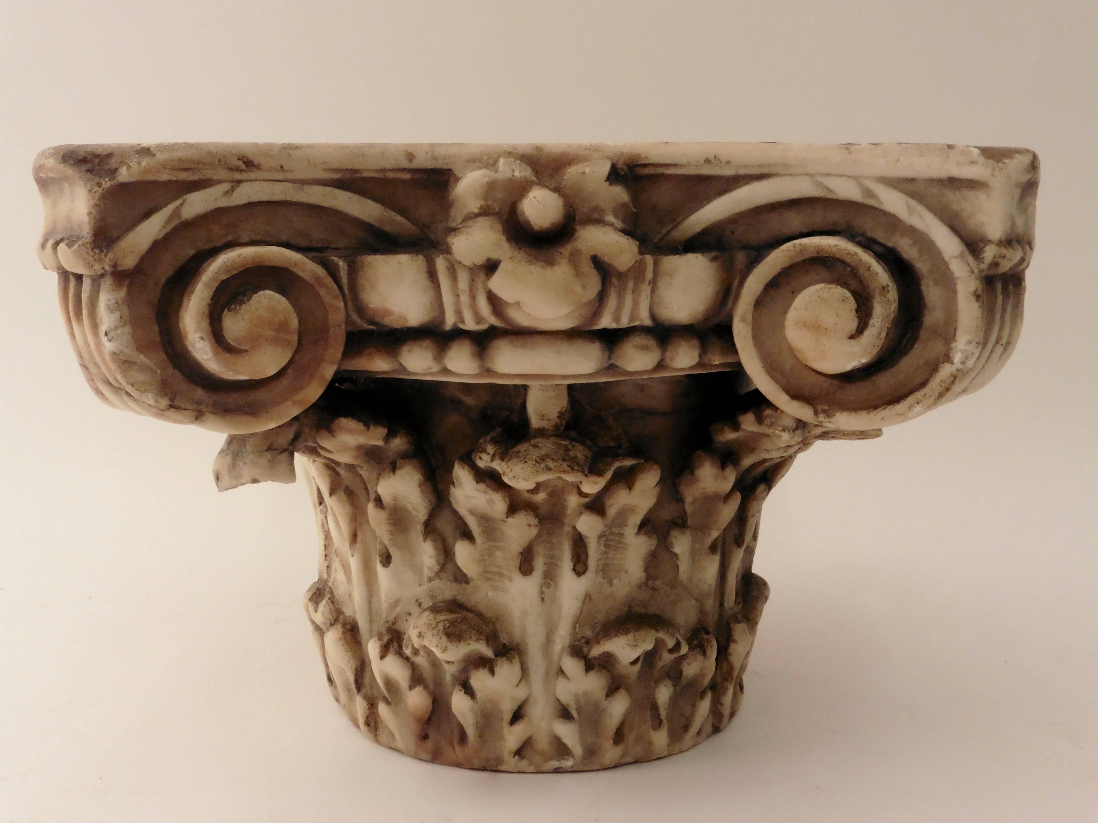 An elaborate carved white marble Corinthian capital decorated with acanthus leaves and scrolls, after the antique. With a hole in the base so that it may be fixed onto a typical slender fluted Corinthian column, Italian, 19th century.