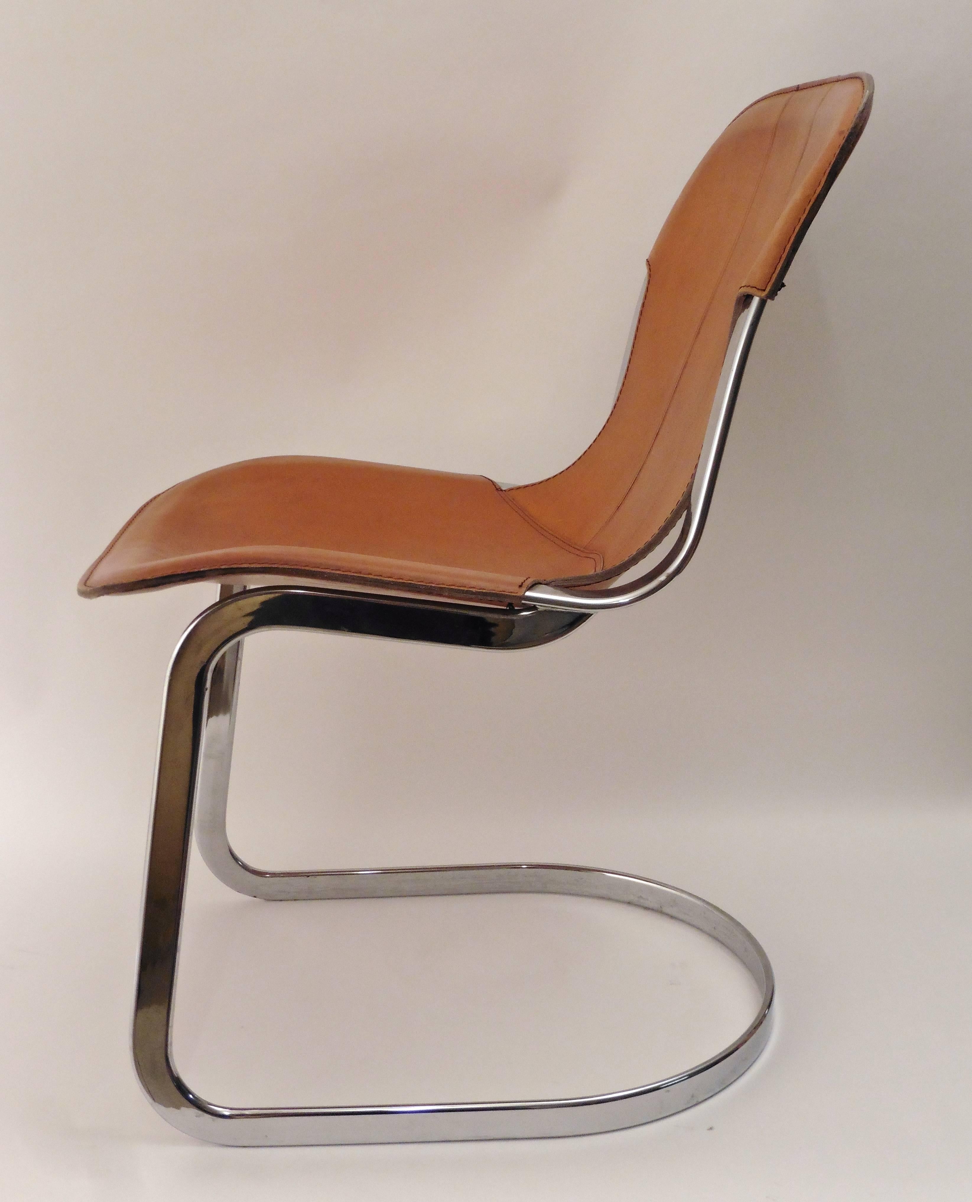 Set of six cantilever dining chairs by Cidue, circa 1970. With stitched tan leather seats on a tubular chrome frame. The leather showing a small amount of wear and tear commensurate with age.