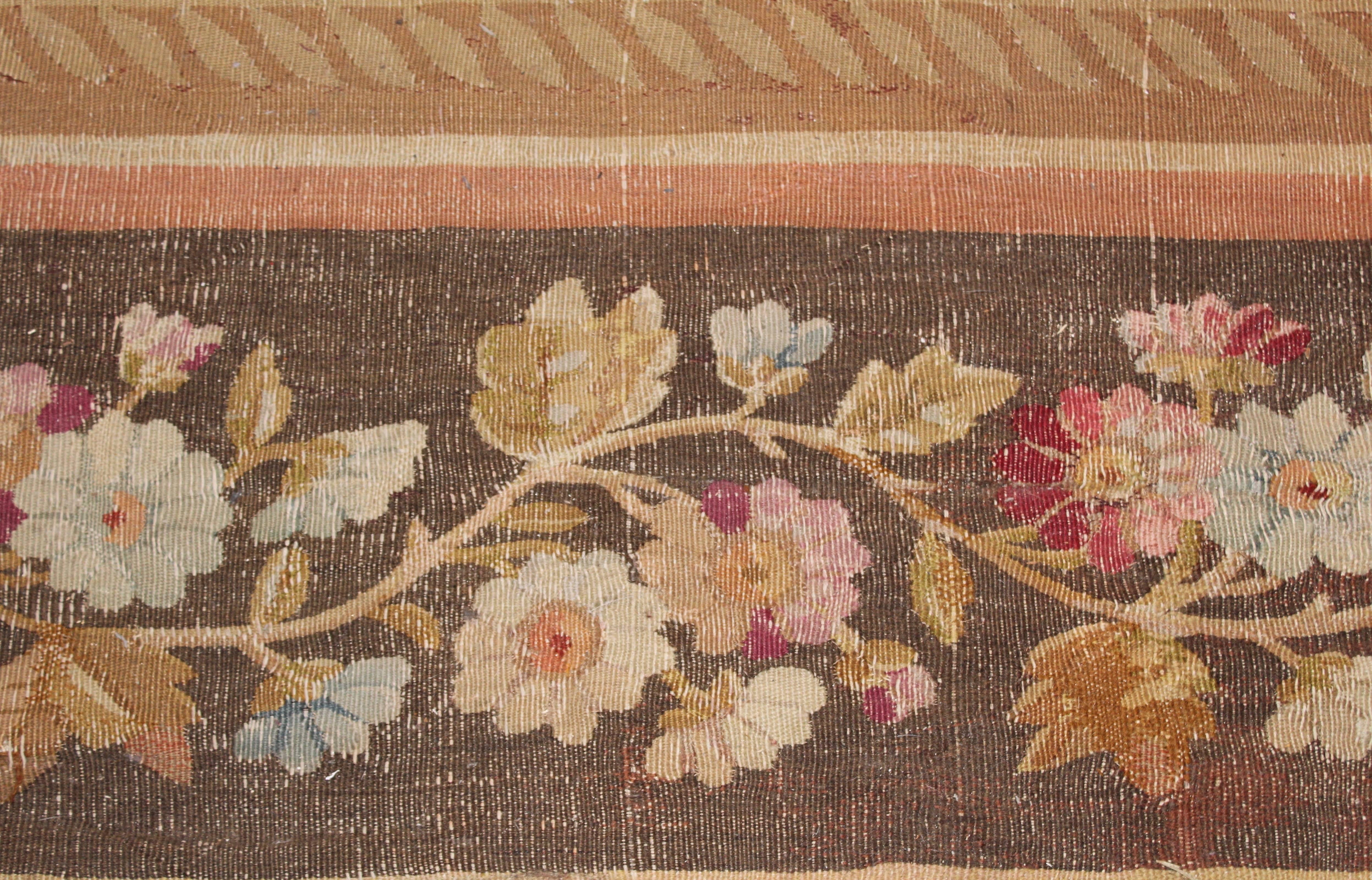 Large Charles X Aubusson woven wool carpet, France, circa 1830. The main focus of this detailed Aubusson carpet is the central, symmetrical flower of geometric patterning, surrounded by a floral wreath. Floral swags emanate from curling flowerpot