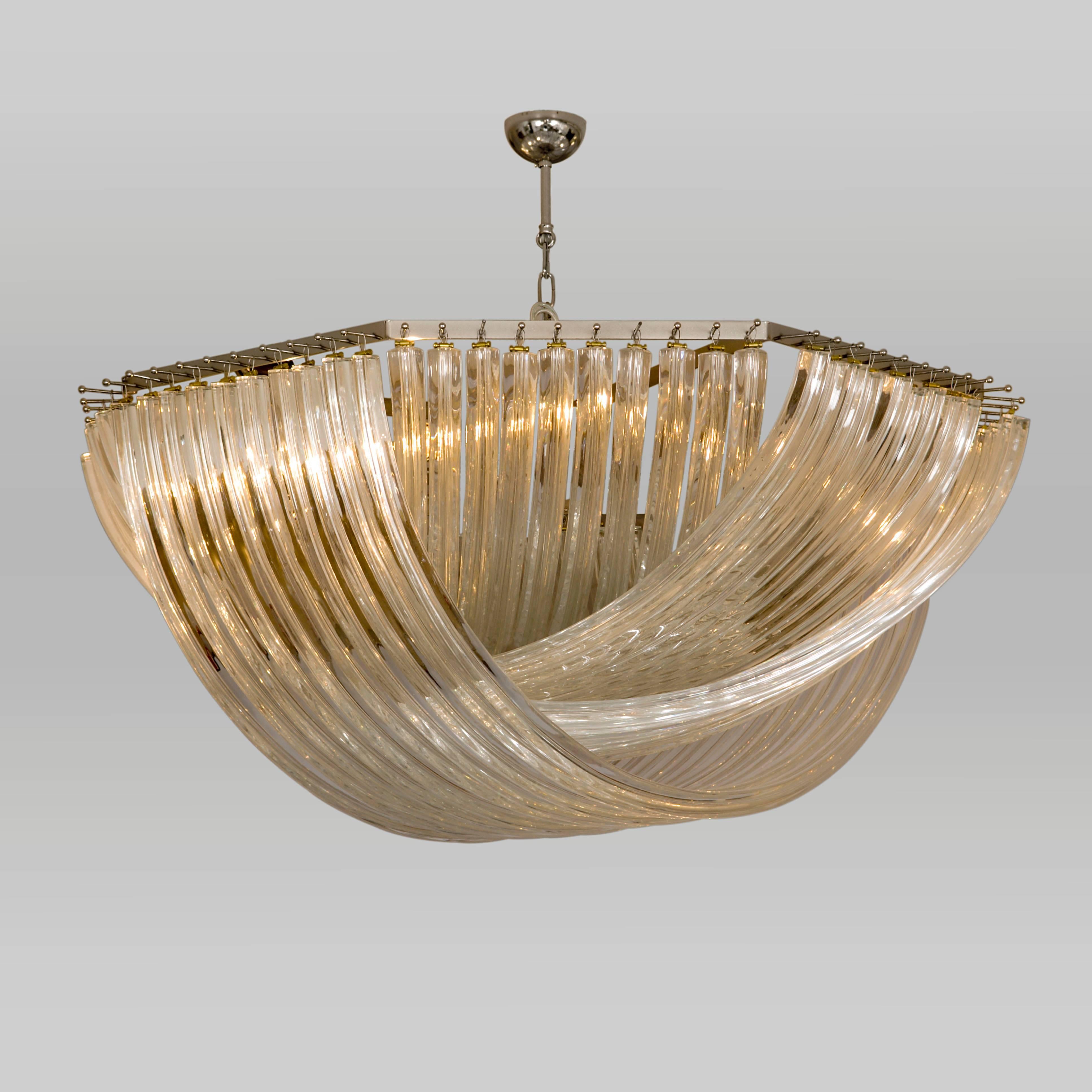 Dramatic and unusual Italian, 1970s-style chandelier using long curved glass rods to create a woven or liquid effect.