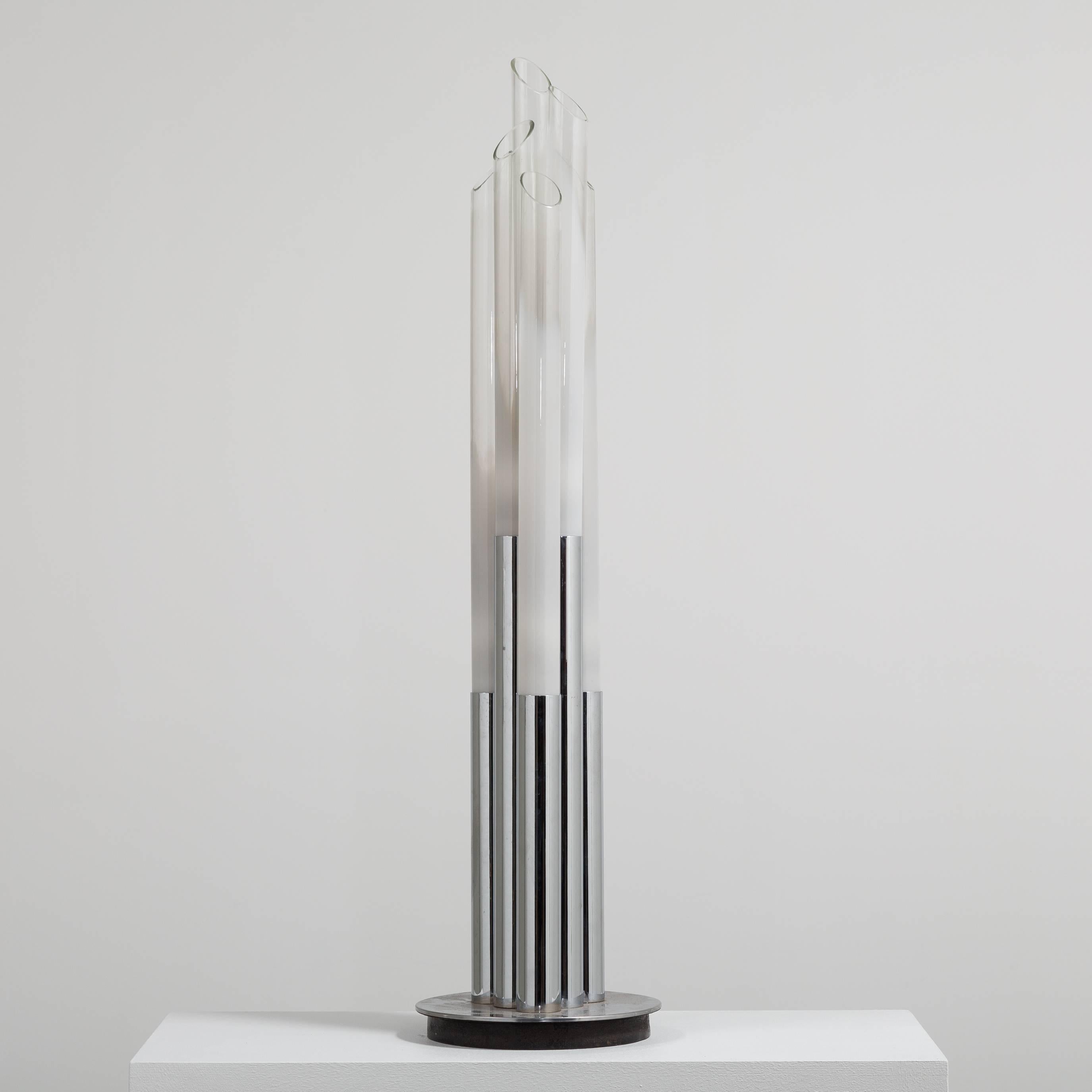 A chrome and glass floor standing lamp, the chrome is wrapped at two heights to glass tubing of differing heights to create a glamorous floor lamp.  late 1960s. 

