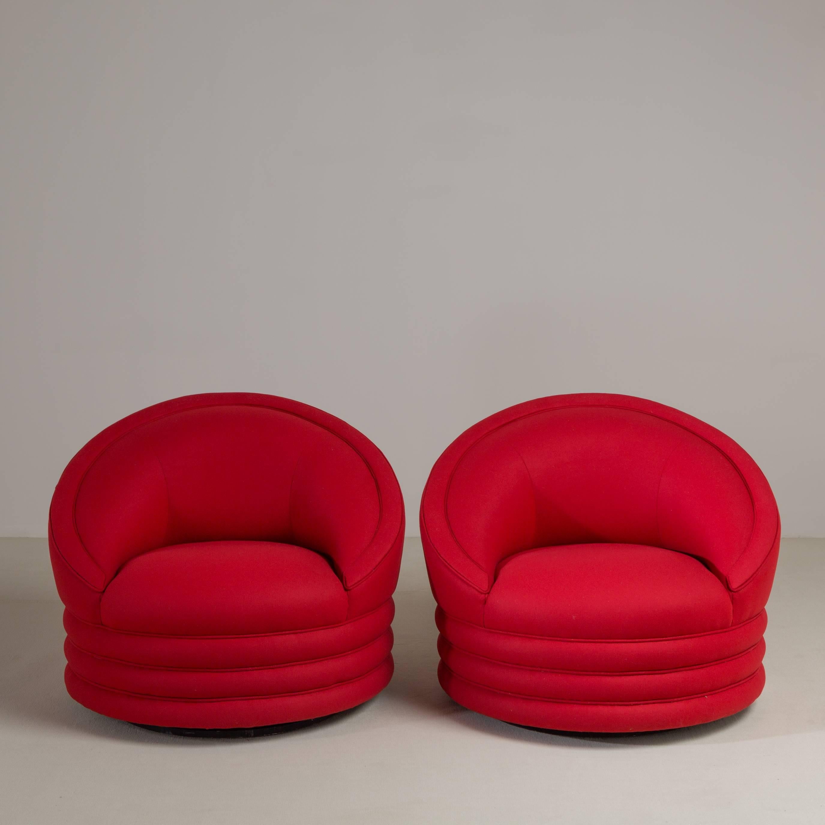 A superb pair of red wool upholstered swivel armchairs, 1980s. A set of four available. Fully reupholstered by Talisman. 