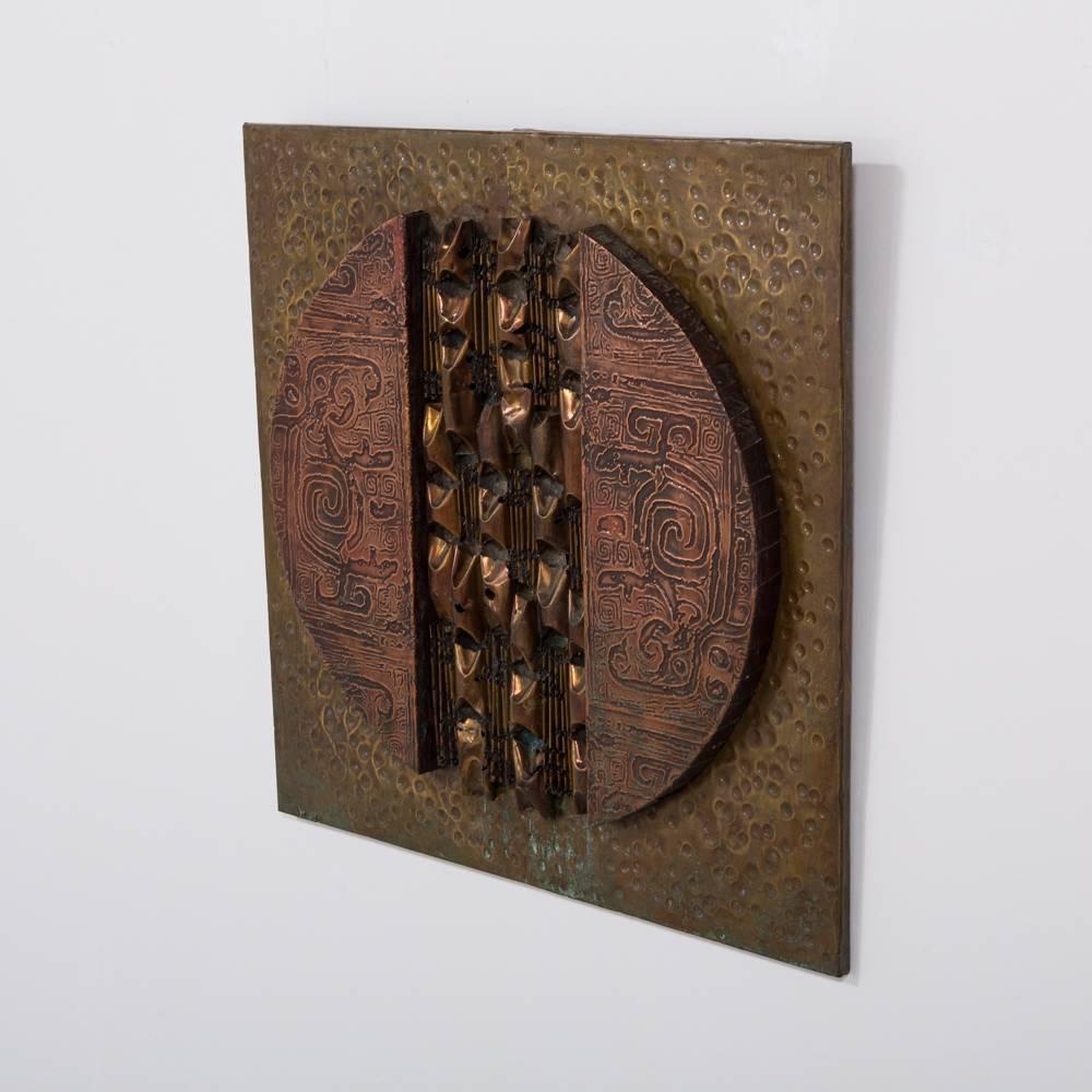 A square Brutalist mixed metal wall panel sculpture, 1970s

The panel is heavily influenced by the work of Paul Vanders and of the same period of design as he was working. Embossed and textured patinated metals on wood.