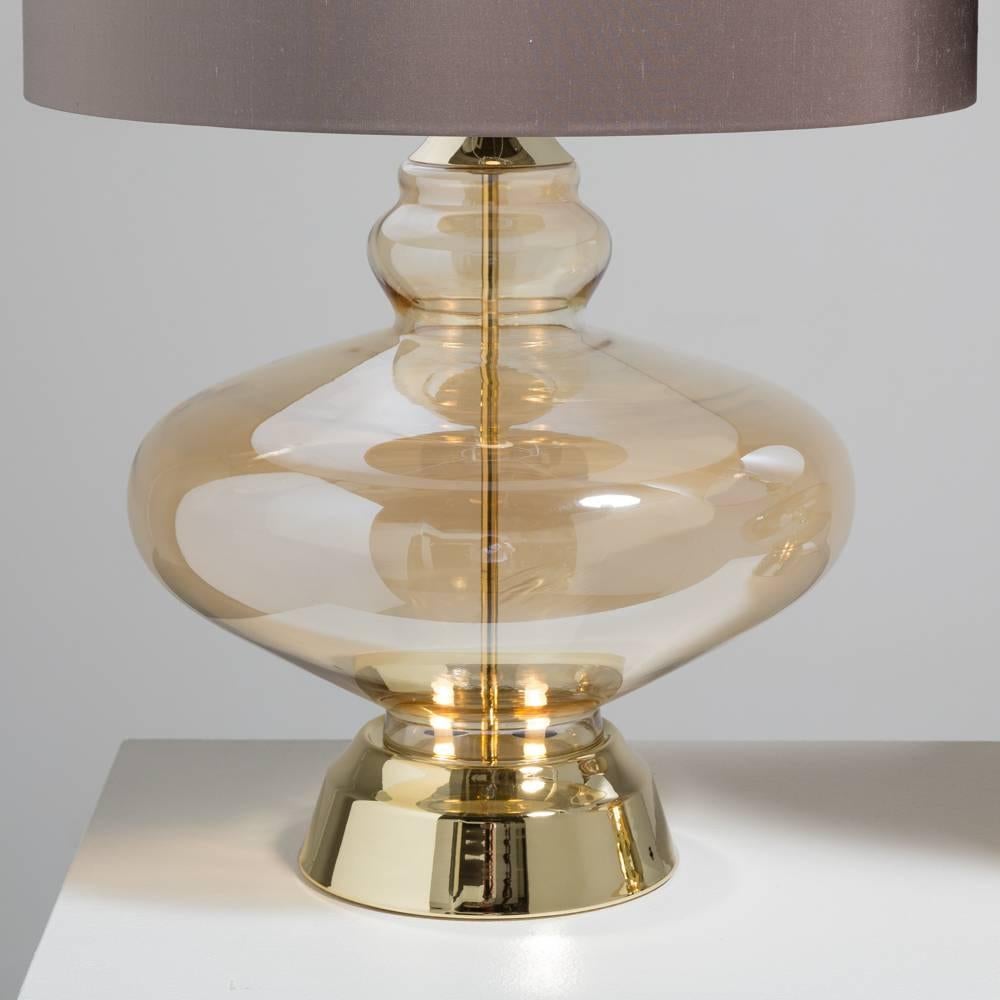 A pair of gold Irridescent Murano glass table lamps on brass mounts, 1960s.

Width at widest point 38cm

Price includes 20% VAT which is removed for items shipped outside the EU.