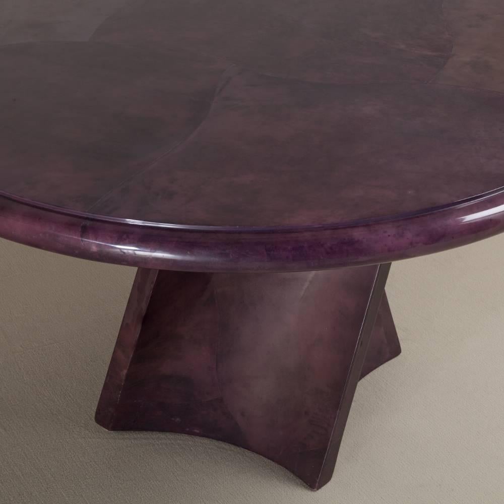 Sculptural twisted pedestal based lacquered mauve goatskin centre table, dated 1991.

 
