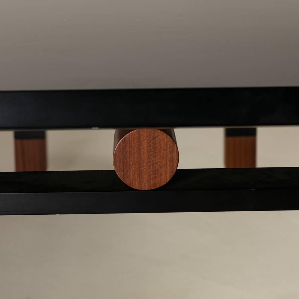 A Saporiti designed extendable ebony and natural lacquered wood dining table, 1980s.

Without its extendable leaf 260cm wide.