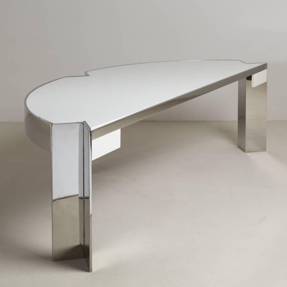 Leon Rosen designed chromium demilune steel desk with triangular cut-out where the legs are placed for Pace collection 1970s with a stunning ivory lacquered top by Talisman.
The desk has two drawers and is known as the 'Mezzaluna' desk.

Pace