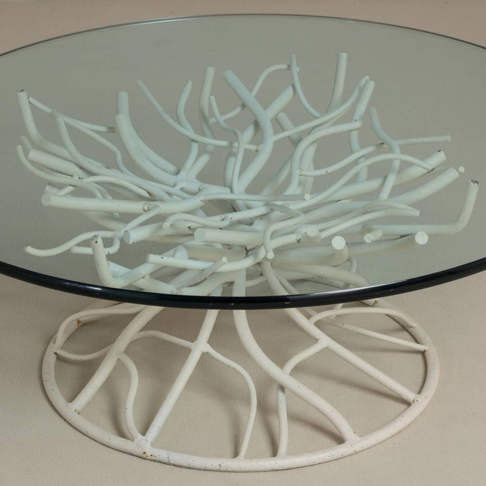 A late 20th century circular cast iron coffee table shaped like a coral. the iron has been painted white. 
Measurements provided are for base- glass top size on request.

