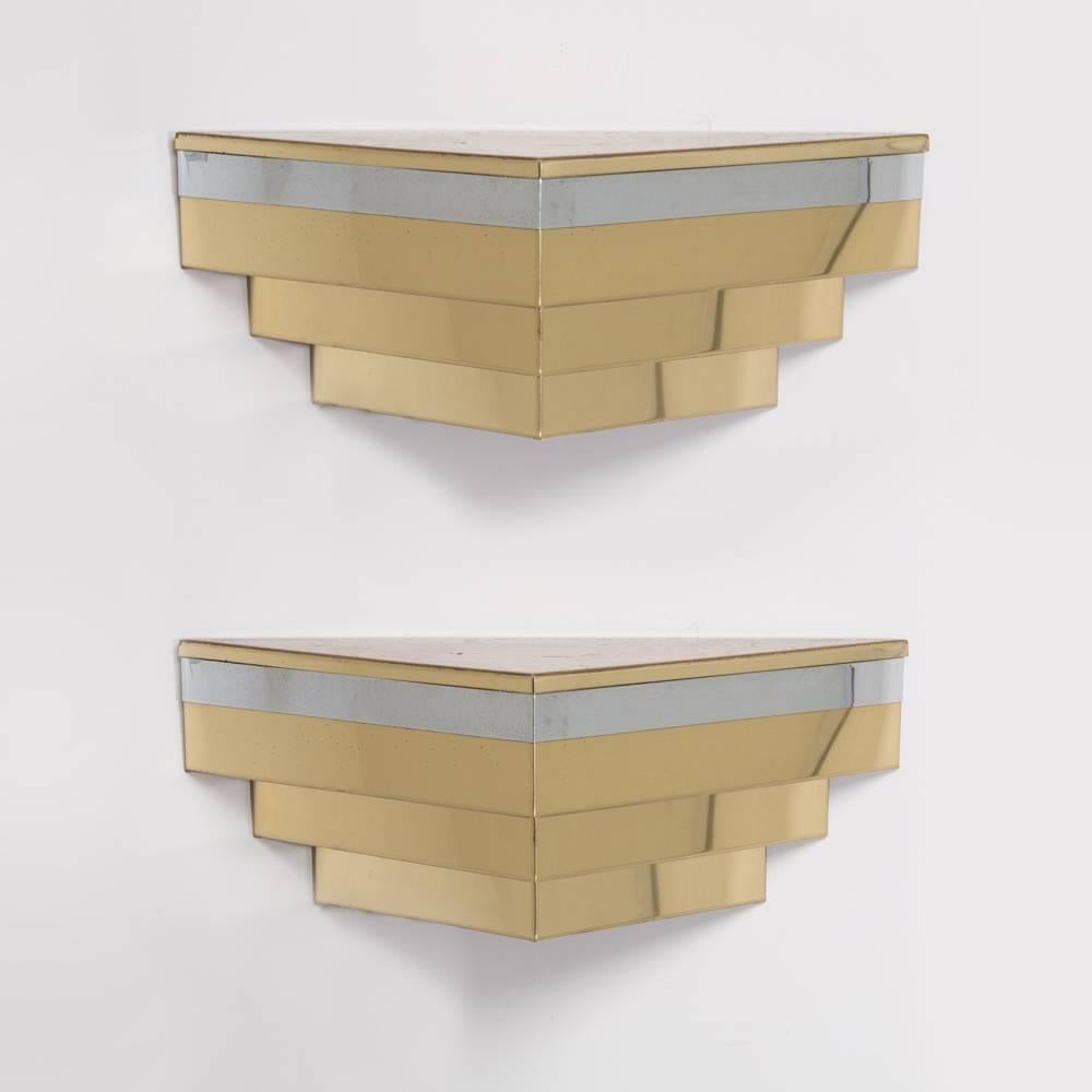 A pair of chrome and brass corner floating shelves in the manner of Curtis Jere, 1980s.

Prices include 20% VAT which is removed for items shipped outside the EU.