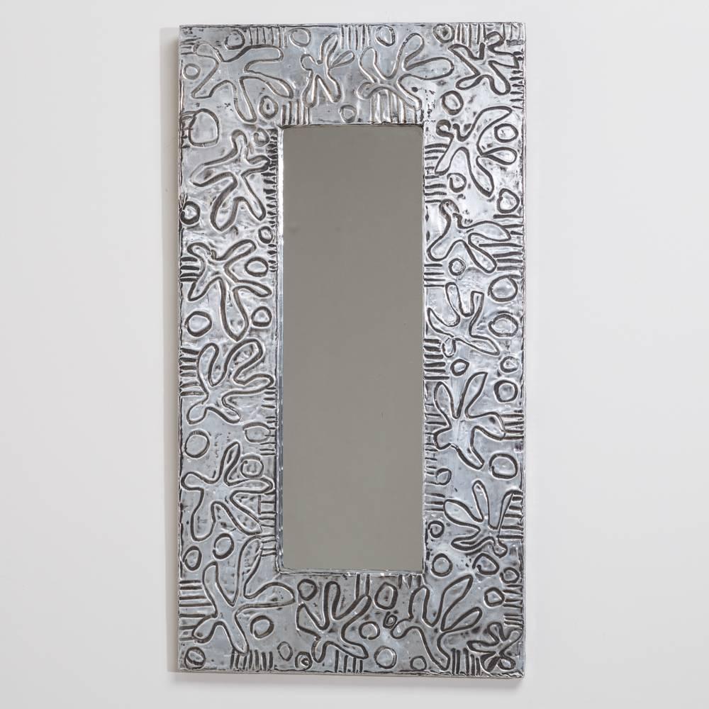 A small embossed aluminium wrapped mirror by Arenson of West Palm Beach, 1980s.

Prices include 20% VAT which is removed for items shipped outside the EU.