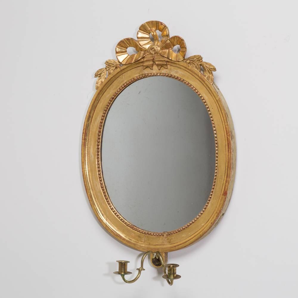 A pair of Swedish oval giltwood mirrors with candle sconces, circa 1760.

NB: These items are subject to a further discount over and above the trade when exported outside the EU of 10%