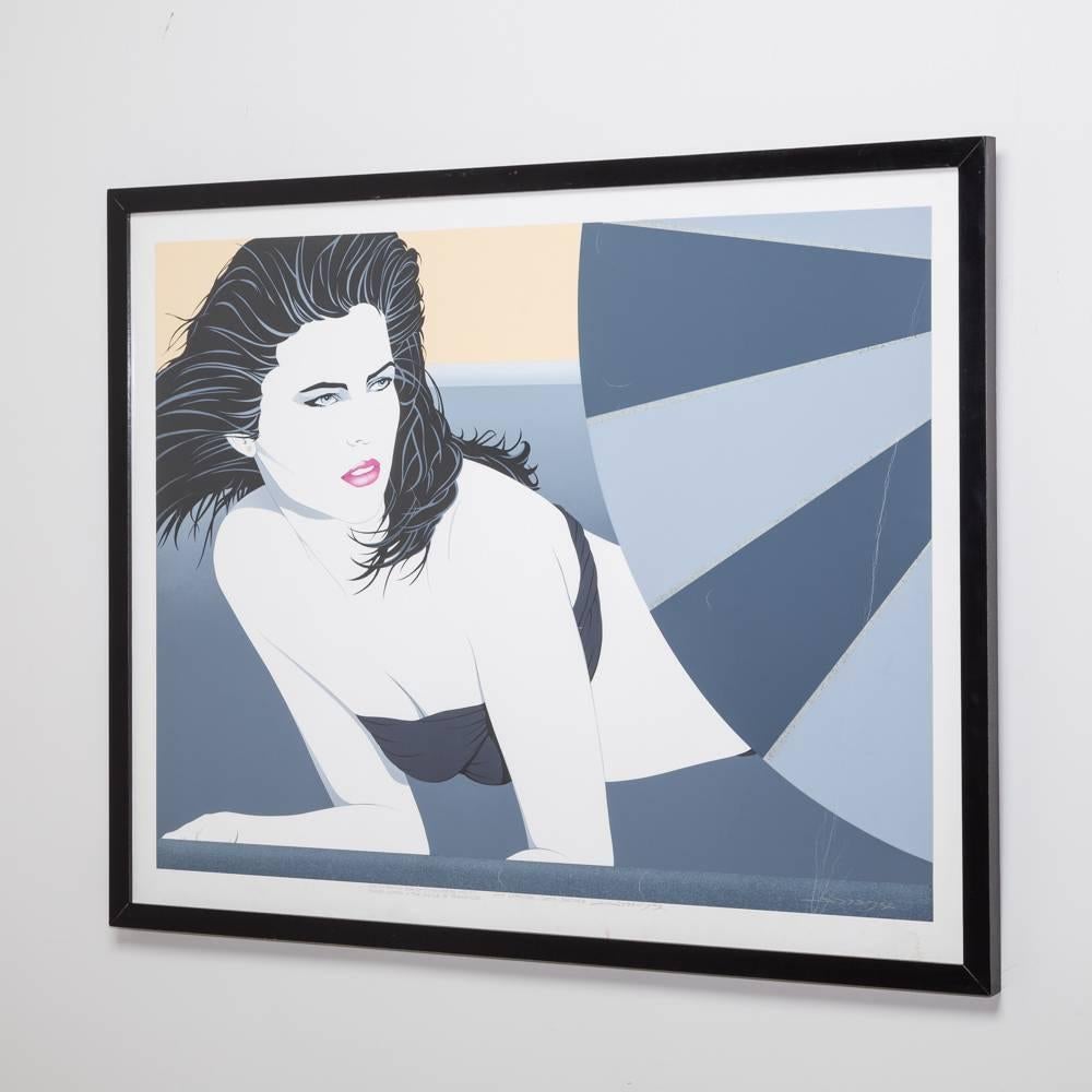 A framed landscape deco style print of a woman 1980s.