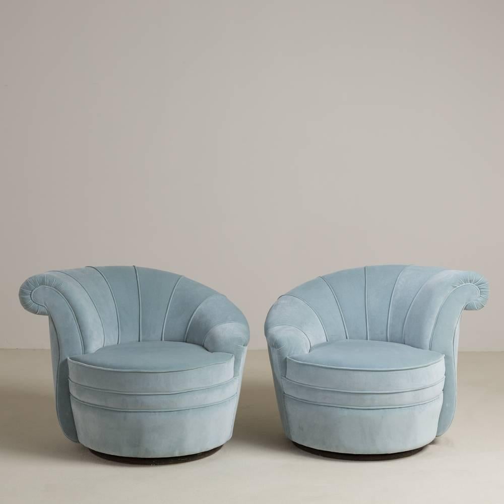 A pair of shell back soft blue velvet upholstered swivel chairs 1970s fully reupholstered by Talisman.

Prices include 20% VAT which is removed for items shipped outside the EU.