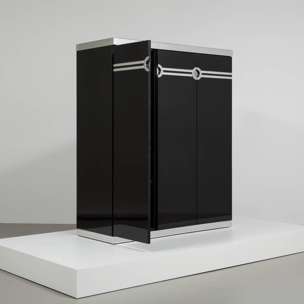 A tall Pierre Cardin designed jet black lacquered three-door wardrobe cabinet 1980s signed, Talisman edition fully reconditioned by Talisman and internally fitted with pull-out drawers and static shelving.