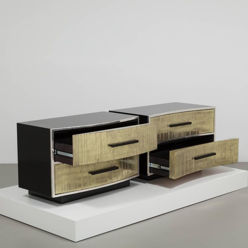 A unique pair of gold leafed detailed two-drawer side cabinets, designed and created by Talisman.