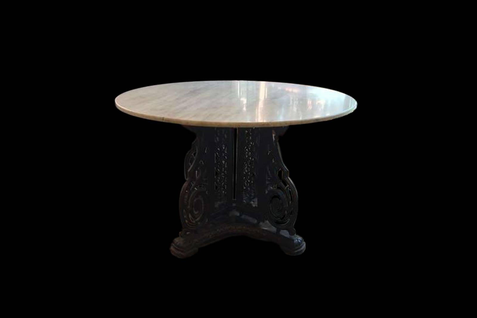 A turn of the century cast iron center table with marble top.  The base is comprised of an extremely detailed iron casting with an ornate wooden plinth below.  This is an extremely elegant and unique piece that would be a fabulous statement in the