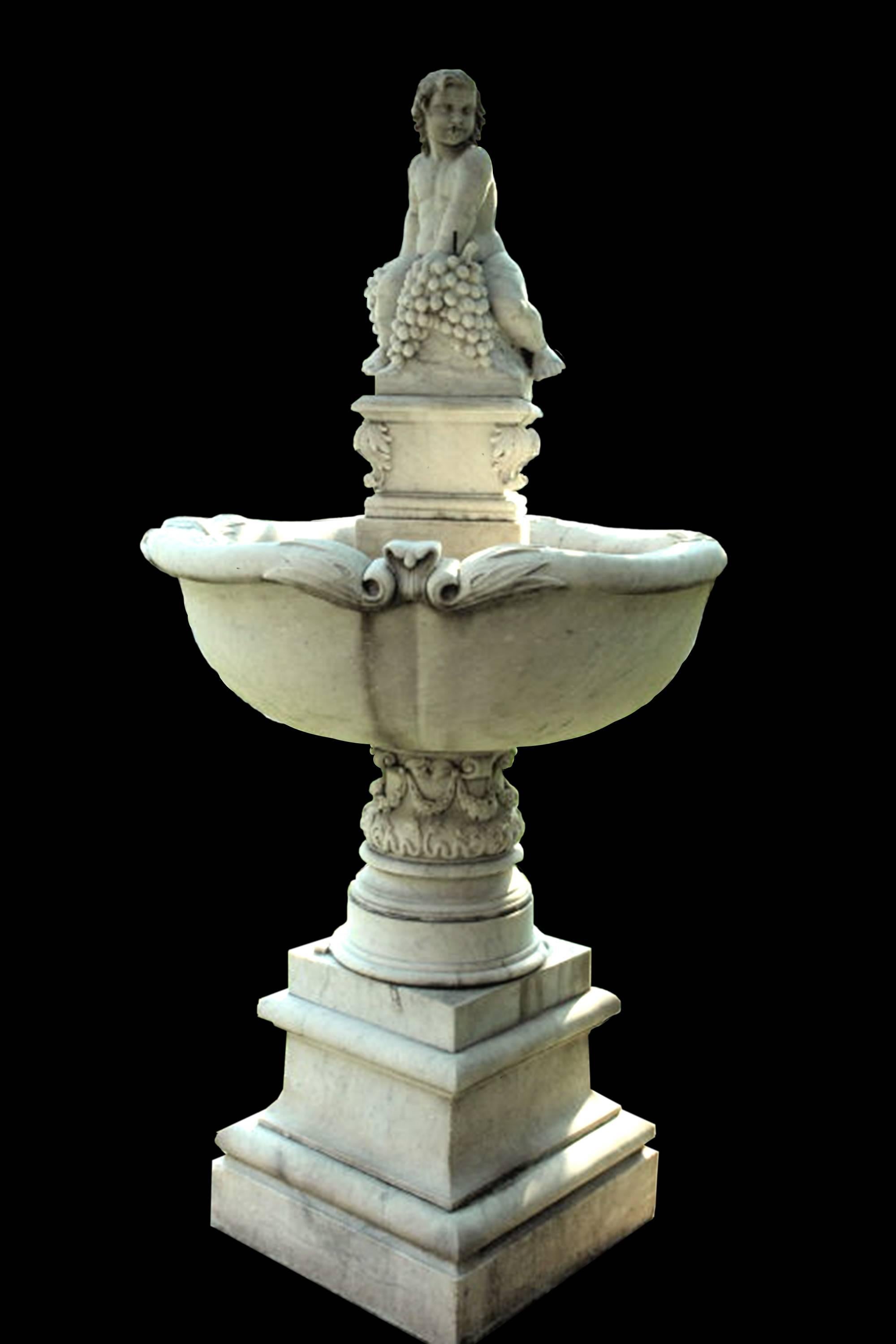 Bacchus marble fountain. American Century Itailian Carrara marble fountain c.1890 with a figure portraying Bacchus as a baby seated atop a round basin.