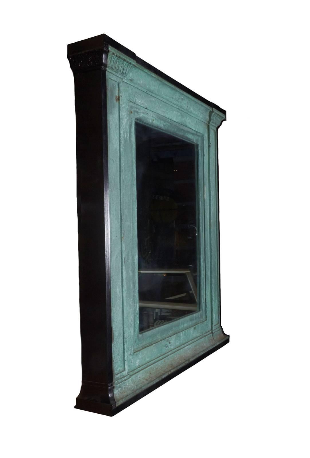 Bronze mirror in original fabulous green patina with ebonized black surround. Converted from exterior building directories.
Pair available.