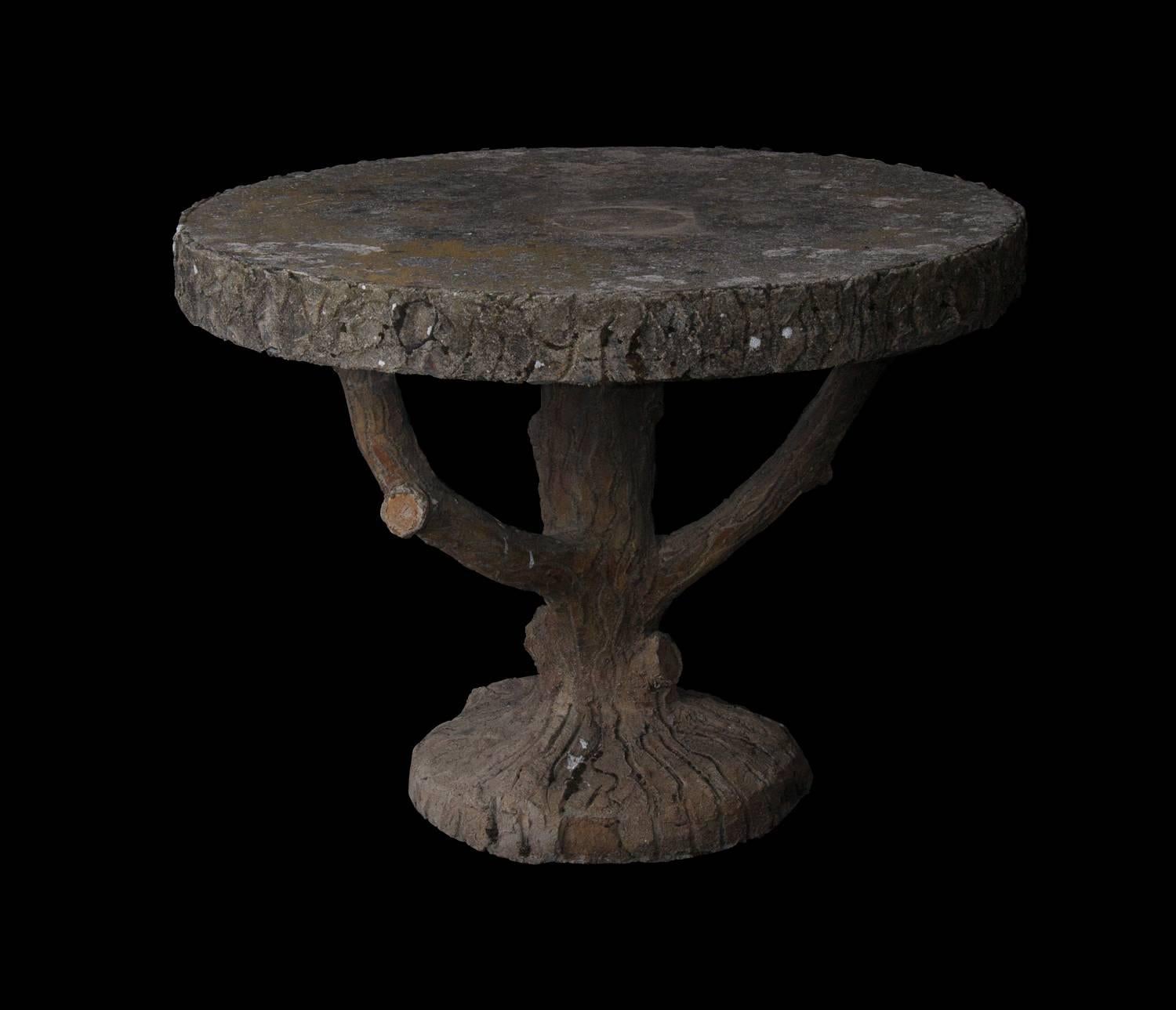 Fabulously antique French faux bois table. Unusual faux trunk base. Perfect for exterior or interior use in a traditional or contemporary setting. Comes with a unique and naturally aged patina.