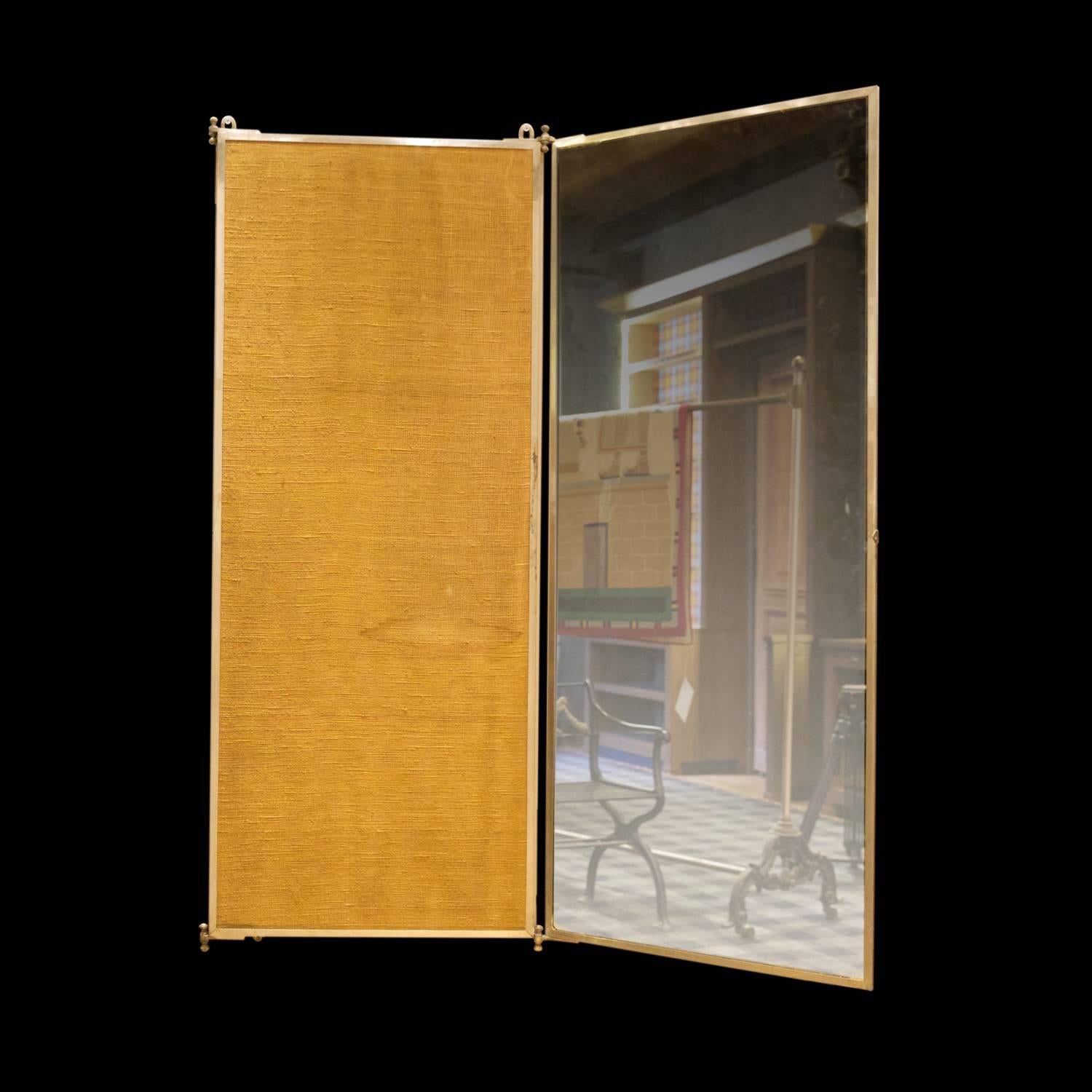 Early 20th century French triptych mirror. This wall hung mirror is made of nickel-plated brass and signed 'Miroir Brot'. It completely folds in, revealing a mustard colored woven linen backing.

Measures: 66" L x 55" H.

 