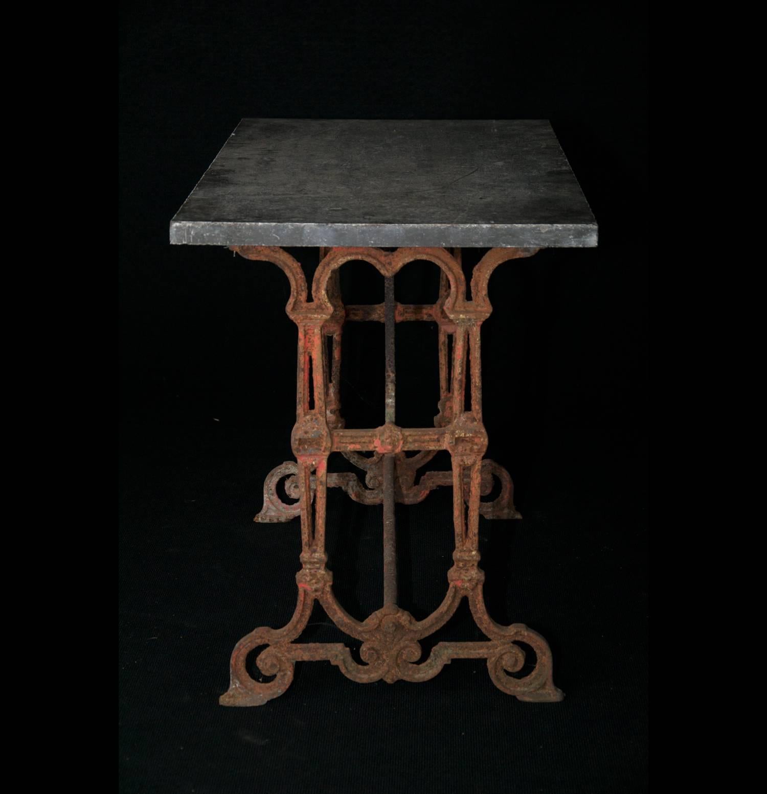 Cast iron table with bluestone top and intricately cast base, circa 1900.

 