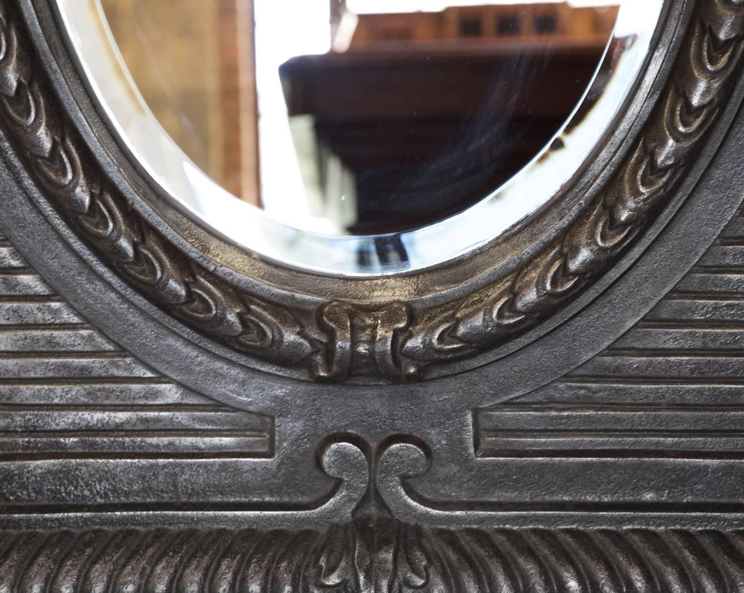 Unusually intricate 19th century cast iron mirror. Unique in form and quality.

Measures: 34" W X 41" H X 5" D.

 